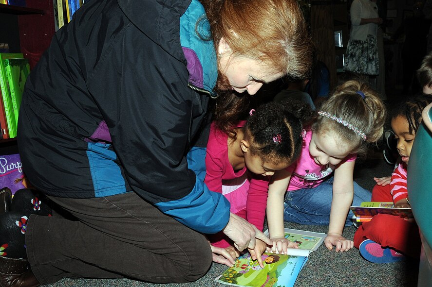 OFFUTT AIR FORCE BASE, Neb. -- Laura Shanahan, wife of 55th Wing Commander Brig. Gen. John N.T. Shanahan, reads a Dora the Explorer book to several chidren from one of Offutt's child development centers March 16 at the base library.  The Shanahans donated more than 450 books to the library in both hard and soft covers for children from birth to eighth grade.  U.S. Air Force photo by Kendra Williams