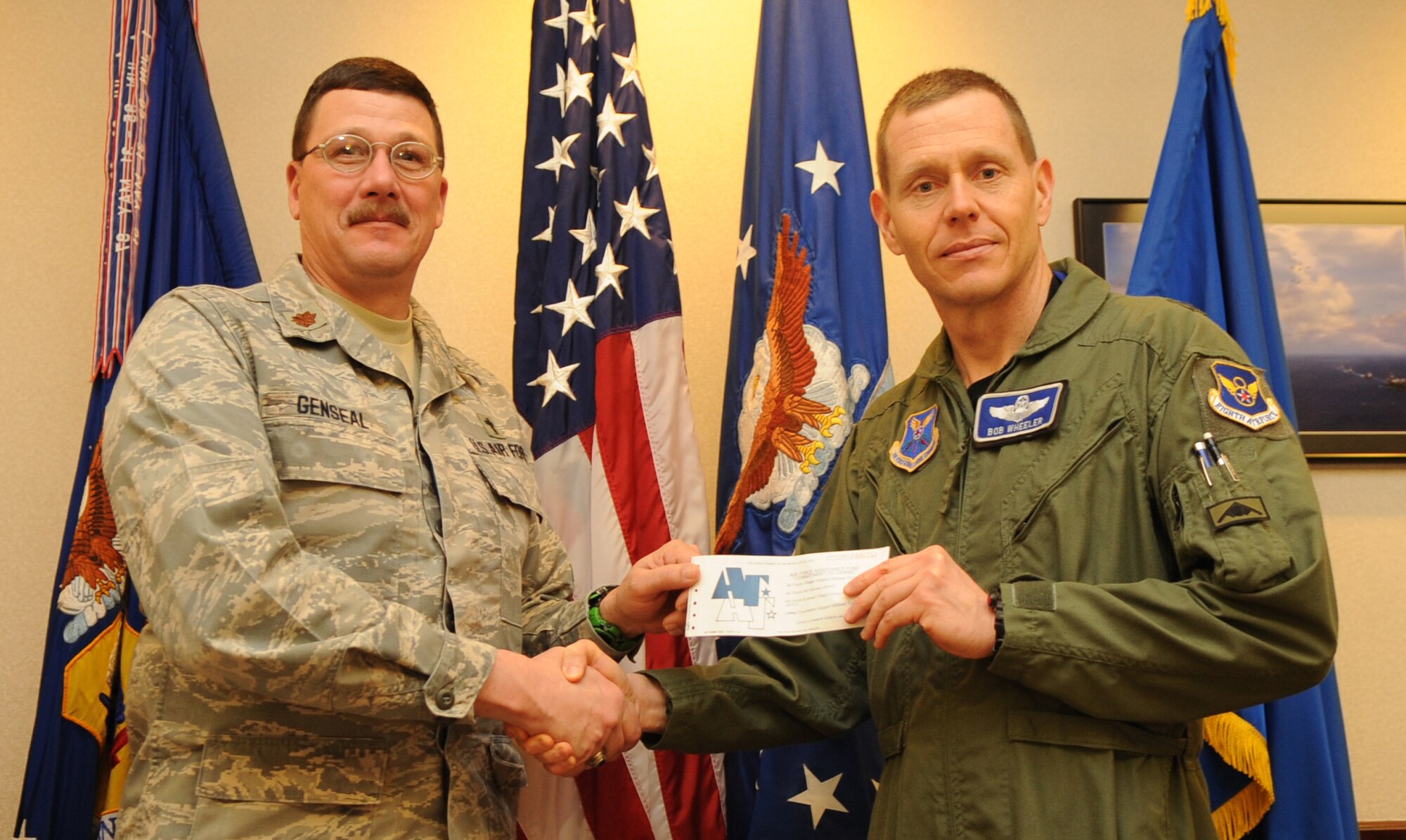 WHITEMAN AIR FORCE BASE, Mo. - Brig. Gen. Robert E. Wheeler, 509th Bomb Wing commander, gives his Air Force Assistance Fund donation form to Chaplain (Maj.) Patrick Genseal, AFAF project officer, March 17, 2010. The Air Force Assistance Fund campaign kicked off March 8, 2010 and will run through April 16, 2010. (U.S. Air Force photo/Senior Airman Stephen Linch)