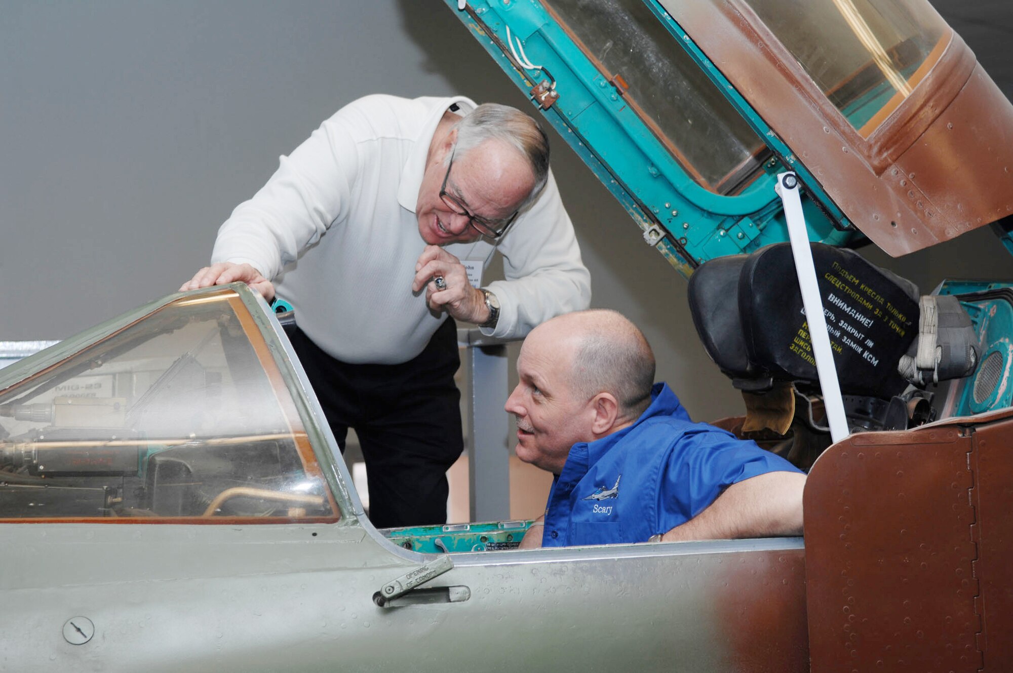 Lt. Col. Doug Schaare (right) and retired Lt. Col. John Peebles check out a MiG-23 Flogger F aircraft static display March 6, 2010, at the threat training facility at Nellis Air Force Base, Nev. Colonel Schaare is a former 55th Fighter Squadron "Shooters" pilot and Colonel Peebles is a ?Shooter? alumnus. (U.S. Air Force photo/2nd Lt. Emily Chilson)