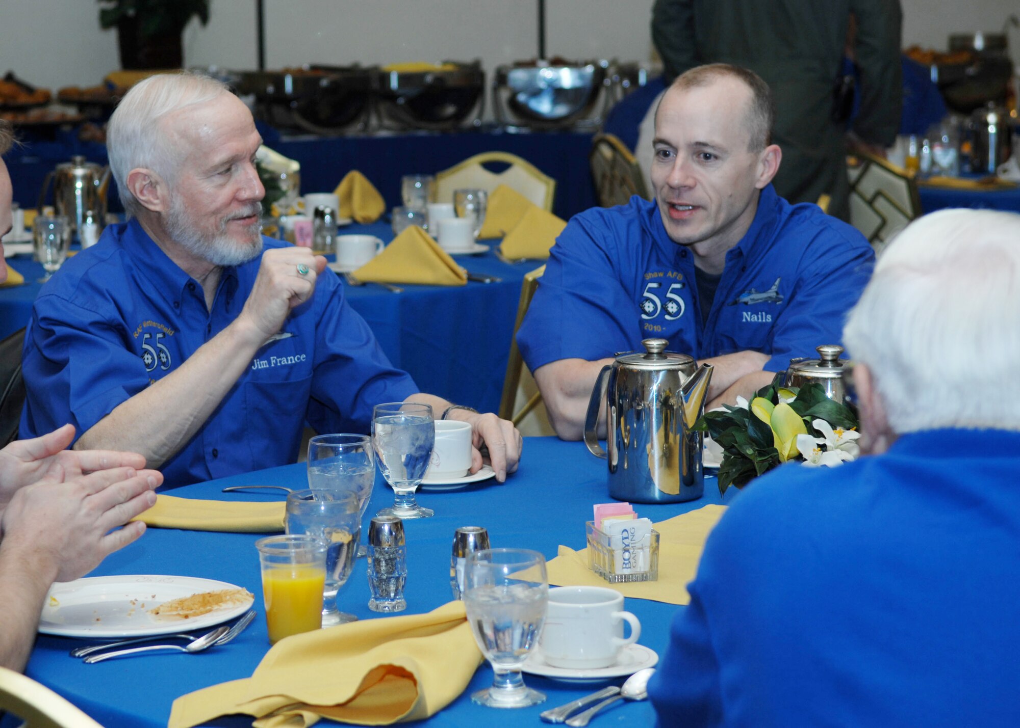 Lt. Col. Jim France (left) speaks with Lt. Col. Jason Plourde during a ?Shooter? reunion breakfast, March 6, 2010, in Las Vegas. Colonel France is a 55th Fighter Squadron "Shooter" alum and Colonel Plourde is the 55th FS director of operations. (U.S. Air Force photo/2nd Lt. Emily Chilson)