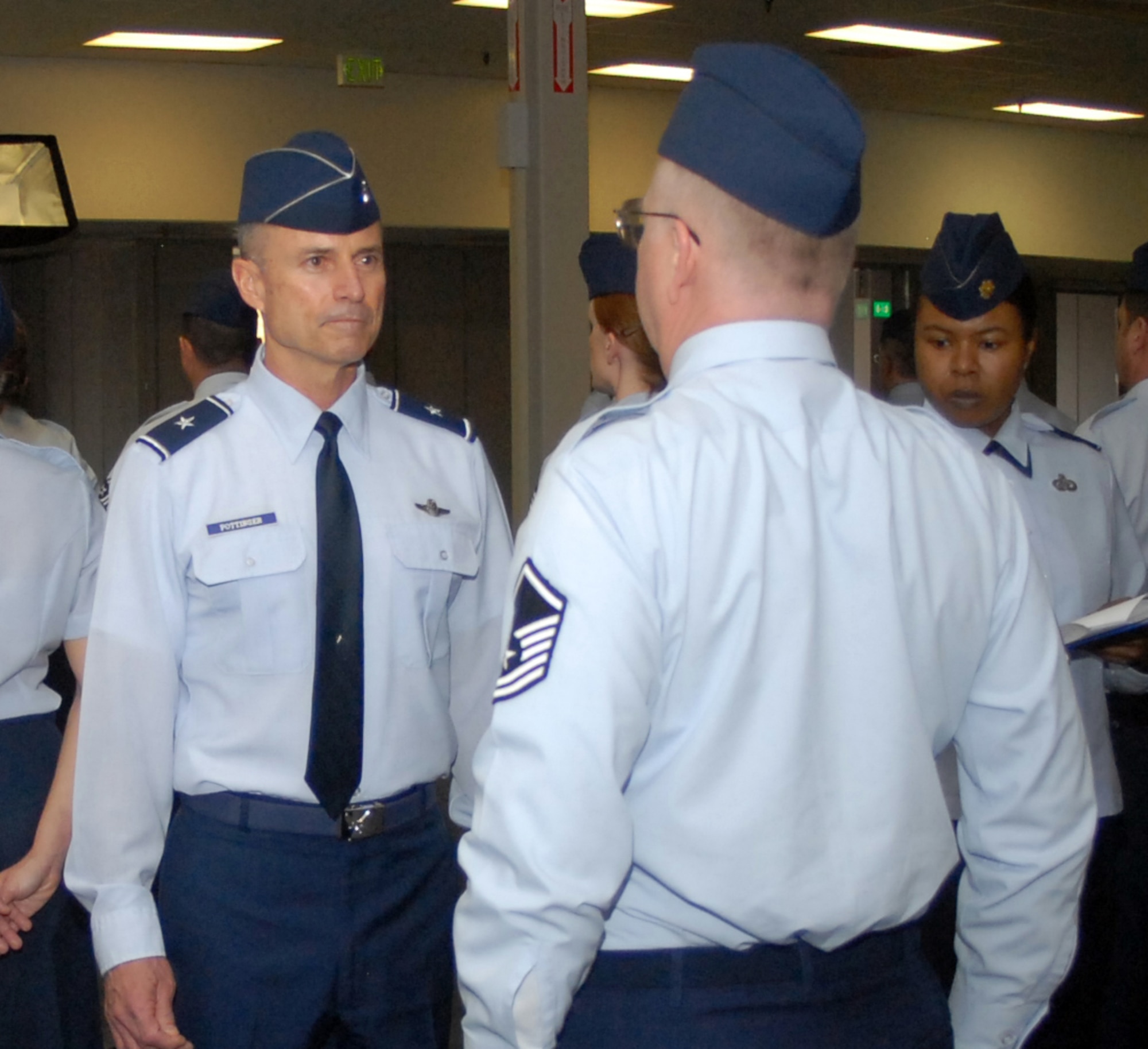 Brig. Gen. Kevin Pottinger, ARPC commander, inspects an Airman at the Air Reserve Personnel Center during an open-ranks inspection March 15. General Pottinger said he held the inspection to remind Airmen of the importance of professionalism and proper dress and appearance. (U.S. Air Force photo/Kevin Bell)