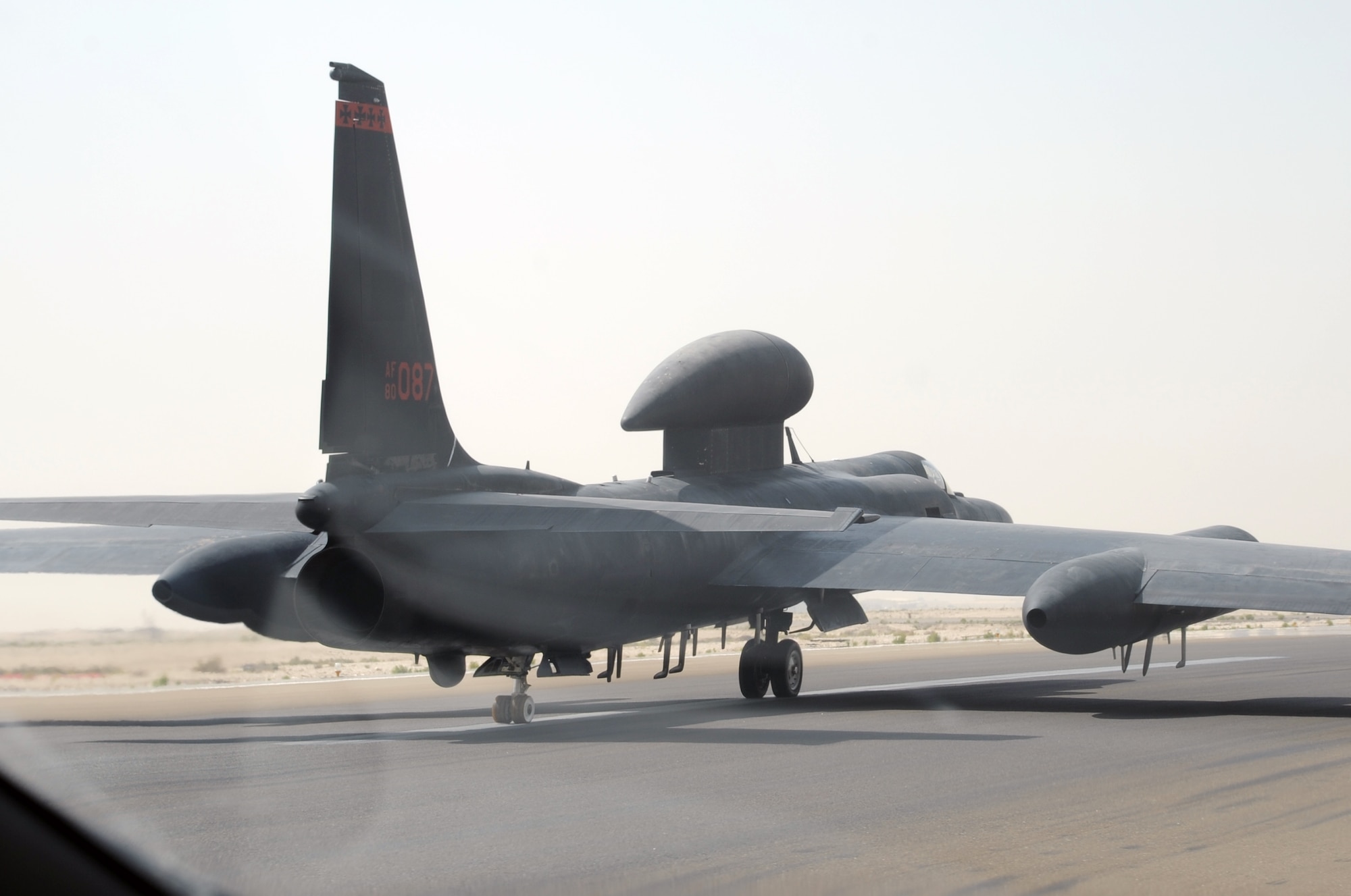 From the window of a chase car, Maj. William Gottenberg, U-2 pilot with the 99th Expeditionary Reconnaissance Squadron, brings a U-2 Dragon Lady in for a landing after completing his 100th combat mission in the U-2 from a non-disclosed base in Southwest Asia on March 9, 2010. The U-2 chase car helps the plane land safely. Major Gottenberg is deployed from Beale Air Force Base, Calif., and his hometown is Rocklin, Calif. (U.S. Air Force Photo/Master Sgt. Scott T. Sturkol/Released)
