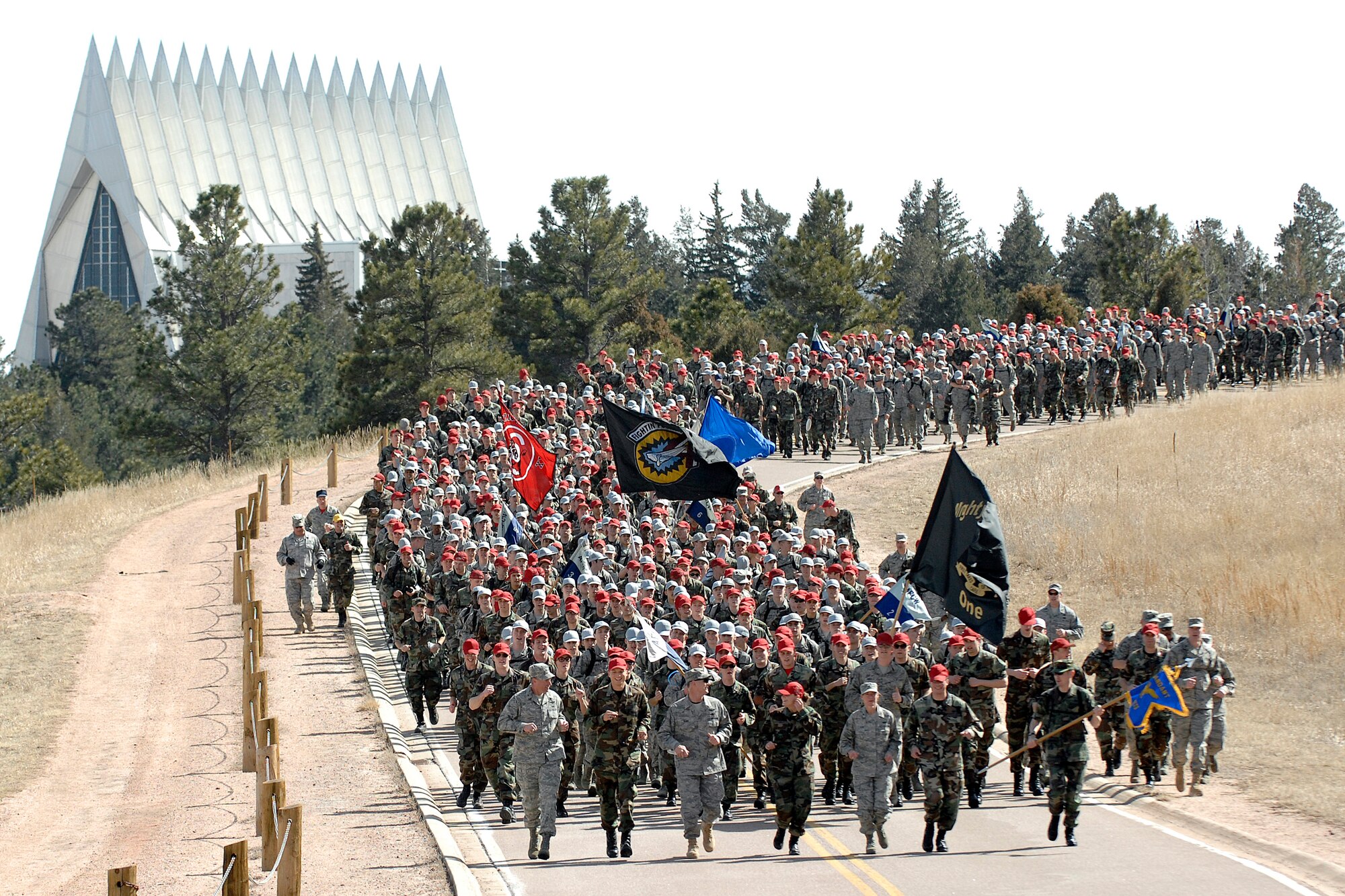 Brig. Gens. Sam Cox and Dana Born and Chief Master Sgt. Richard Ross lead the Class of 2013 on the Run to the Rock during Recognition at the Air Force Academy March 13, 2010. Recognition consists of several days of mentally and physically demanding activities and culminates with the ascension of the freshmen into the ranks of upper-class cadets. General Cox is the commandant of cadets, and General Born is the dean of the faculty. Chief Ross is the commandant of cadets' superintendent. (U.S. Air Force photo/Mike Kaplan)
