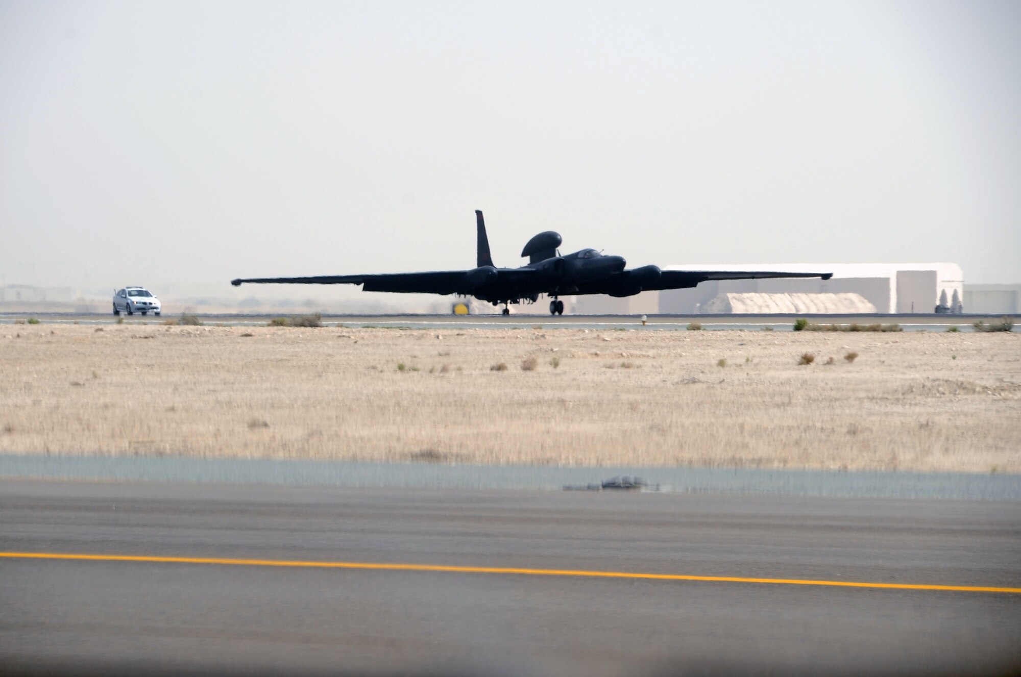 Maj. William Gottenberg, U-2 pilot with the 99th Expeditionary Reconnaissance Squadron, brings a U-2 Dragon Lady in for a landing after completing his 100th combat mission in the U-2 from a non-disclosed base in Southwest Asia on March 9, 2010. Following the U-2 is a chase car that helps the plane land safely. Major Gottenberg is deployed from Beale Air Force Base, Calif., and his hometown is Rocklin, Calif. (U.S. Air Force Photo/Master Sgt. Scott T. Sturkol/Released)