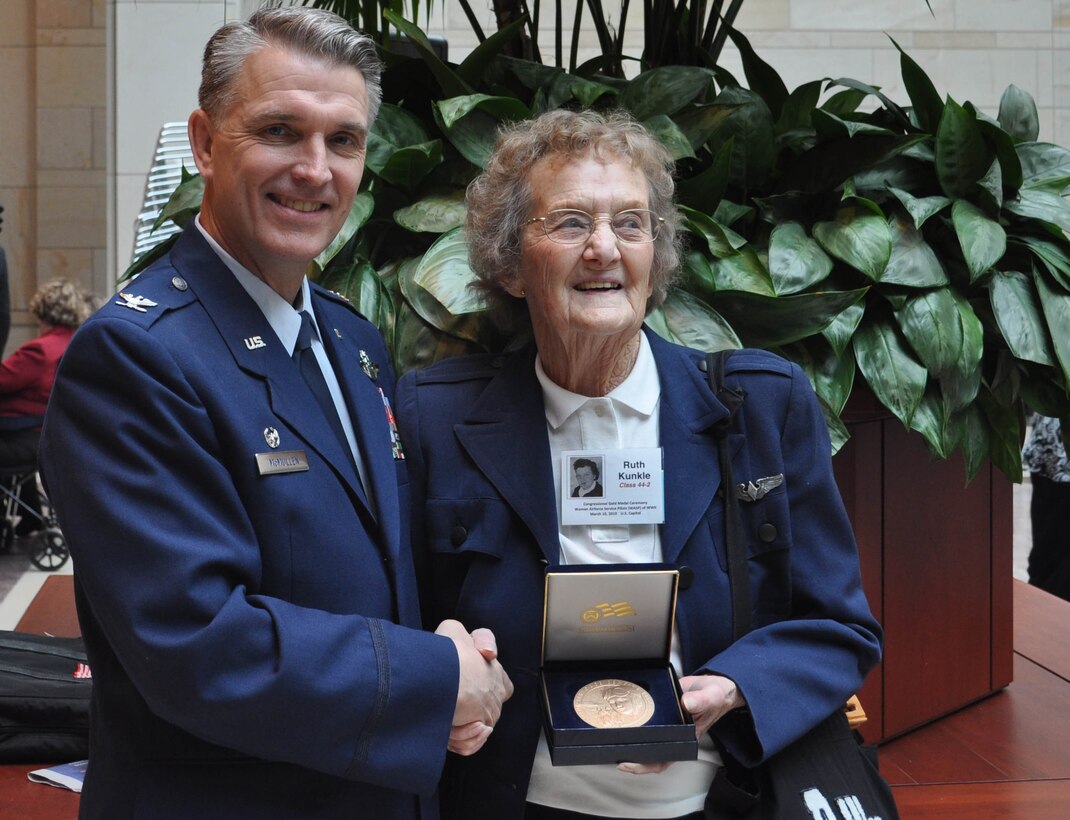 JOINT BASE MCGUIRE-DIX-LAKEHURST, N.J. - Col. Giordano B. McMullen, commander of the Reserve wing here, congratulates Ruth Kunkle for her military service performed during World War II. Mrs. Kunkle is one of about 180 Women AirForce Service Pilots who made the trip to the nation's capitol to receive recognition and thanks for their service performed during World War II. With less than 300 WASPs alive today, those present at the March 10 WASP Gold Medal Ceremony on Capitol Hill, Washington, D.C. recevied a Congressional Medal of Honor. (U.S. Air Force photo/Capt. Kelly A. Smyth)