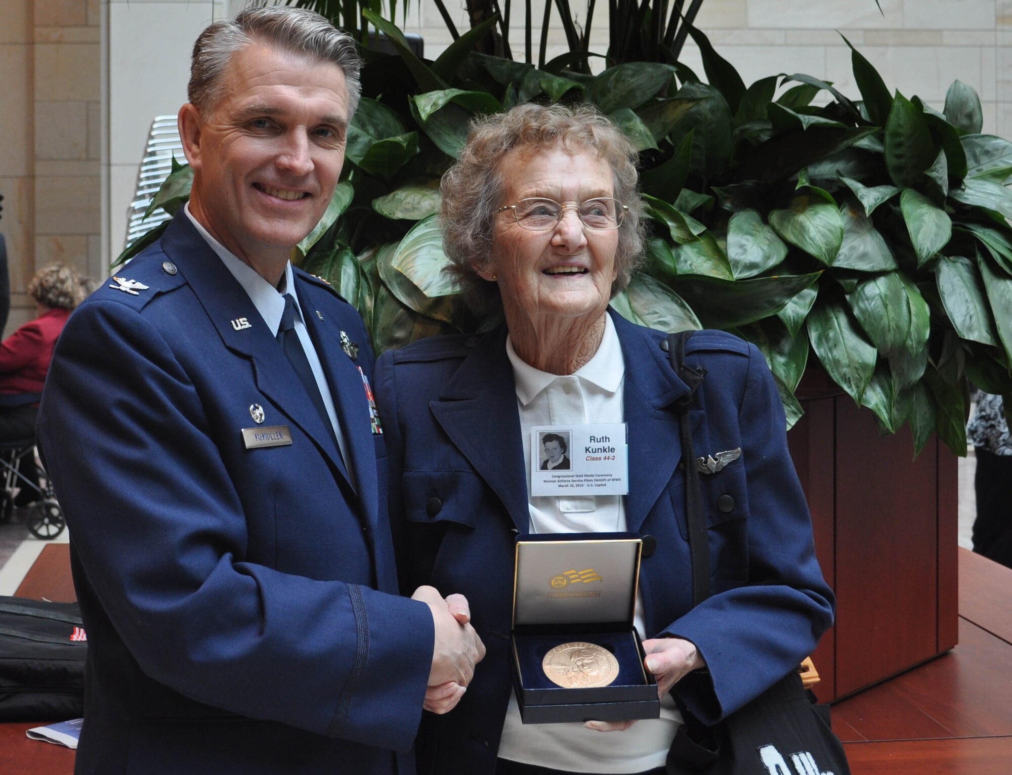 JOINT BASE MCGUIRE-DIX-LAKEHURST, N.J. - Col. Giordano B. McMullen, commander of the Reserve wing here, congratulates Ruth Kunkle for her military service performed during World War II. Mrs. Kunkle is one of about 180 Women AirForce Service Pilots who made the trip to the nation's capitol to receive recognition and thanks for their service performed during World War II. With less than 300 WASPs alive today, those present at the March 10 WASP Gold Medal Ceremony on Capitol Hill, Washington, D.C. recevied a Congressional Medal of Honor. (U.S. Air Force photo/Capt. Kelly A. Smyth)