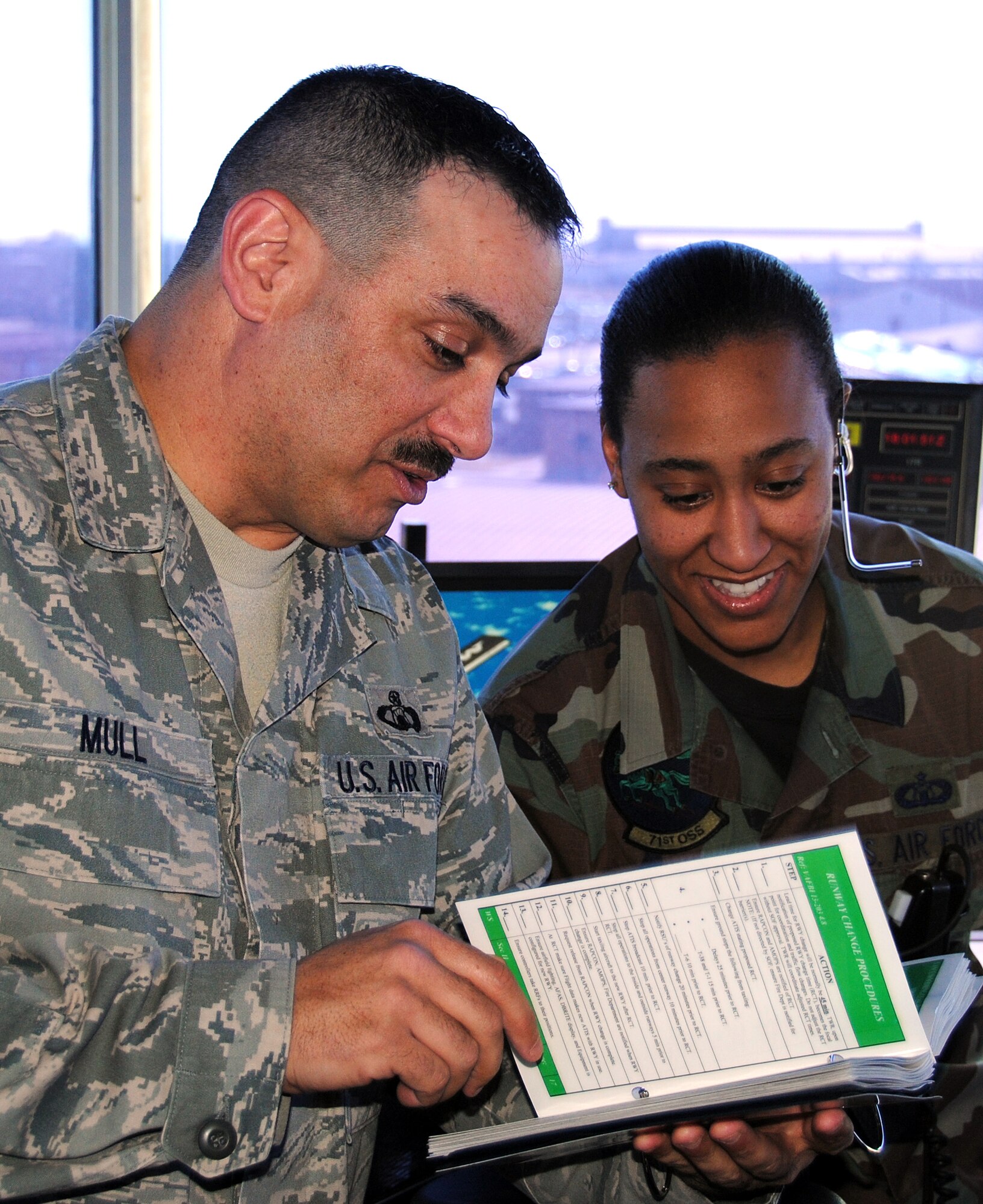 Master Sgt. James Mull, with the 71st Operations Support Squadron air traffic control tower, briefs with Staff Sgt. Ashonda Williams, 71st OSS. Sergeant Mull was named Air Traffic Control Enlisted Manager of the Year in the 2009 Air Education and Training Command Airfield Operations Awards. (U.S. Air Force photo/ Ensign Rex Miller)