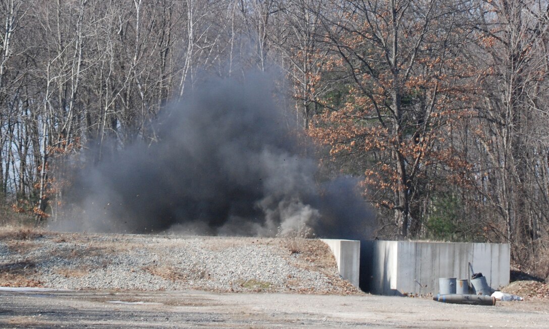 Rocks fly and a cloud of black smoke rises from the detonation area during an EOD training exercise. This training is designed to protect reservists who are deploying to areas overseas. (U.S. Air Force photo/Senior Airman George Cloutier)