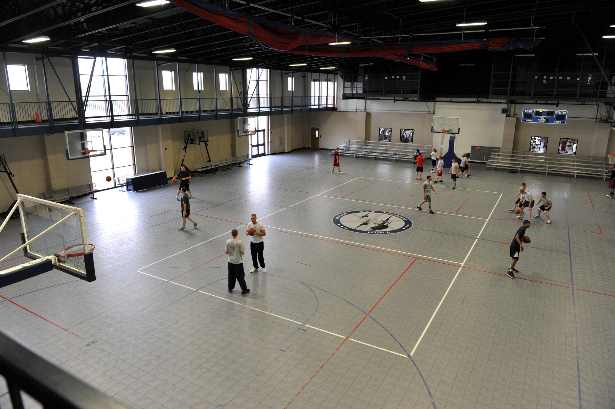 People play basketball at the fitness center's gym. The gym area is used for an array of sports and squadron physical training. (U.S. Air Force photo by Senior Airman Christine Clark)