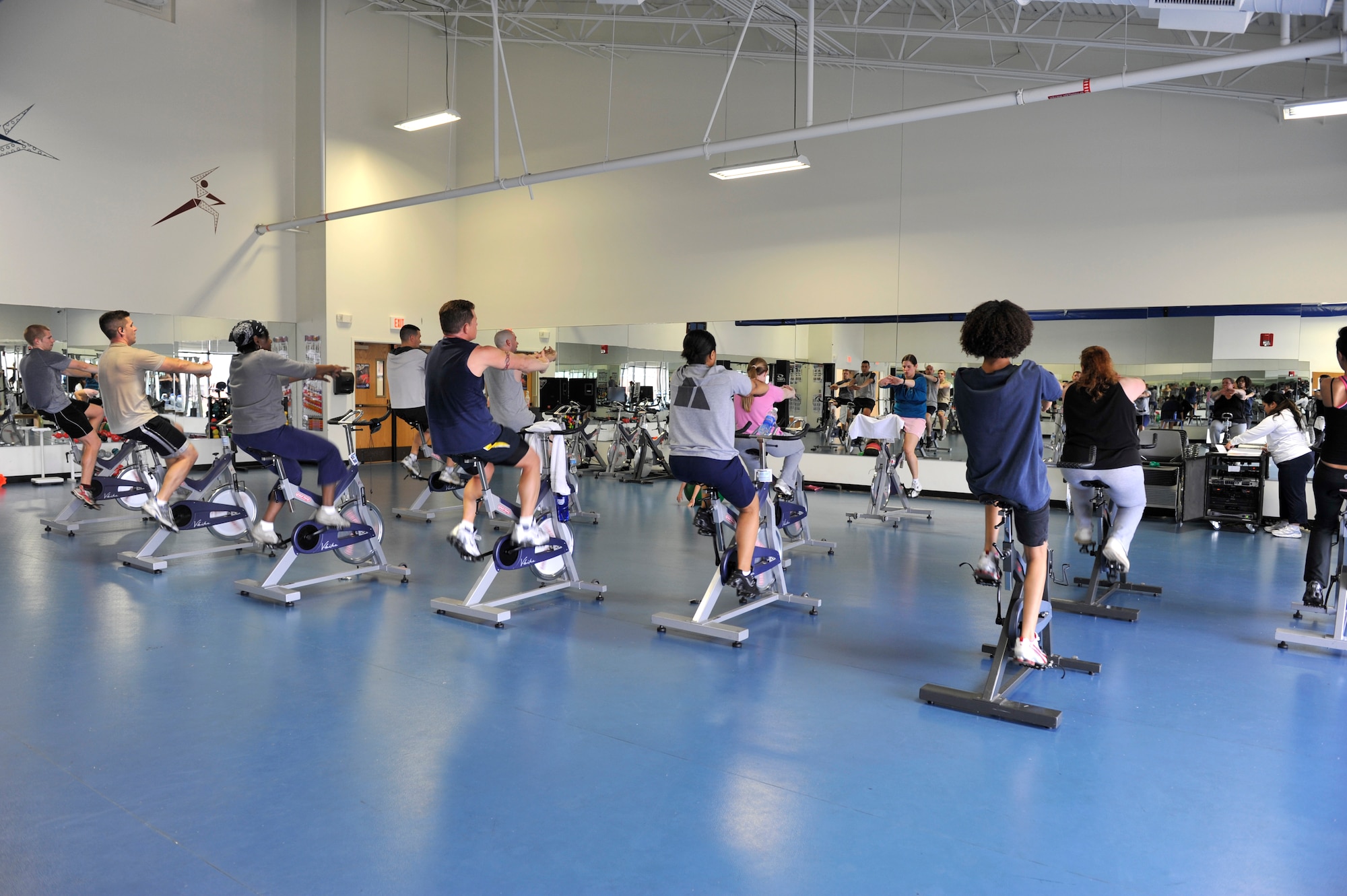 Maj. Kat Callaghan, 314th Airlift Wing deputy chief of plans and programs, instructs a spin class at the fitness center aerobics room March 16. Spin classes are recommended for people who are recovering from injury and want to keep their weight down. (U.S. Air Force photo by Senior Airman Christine Clark)