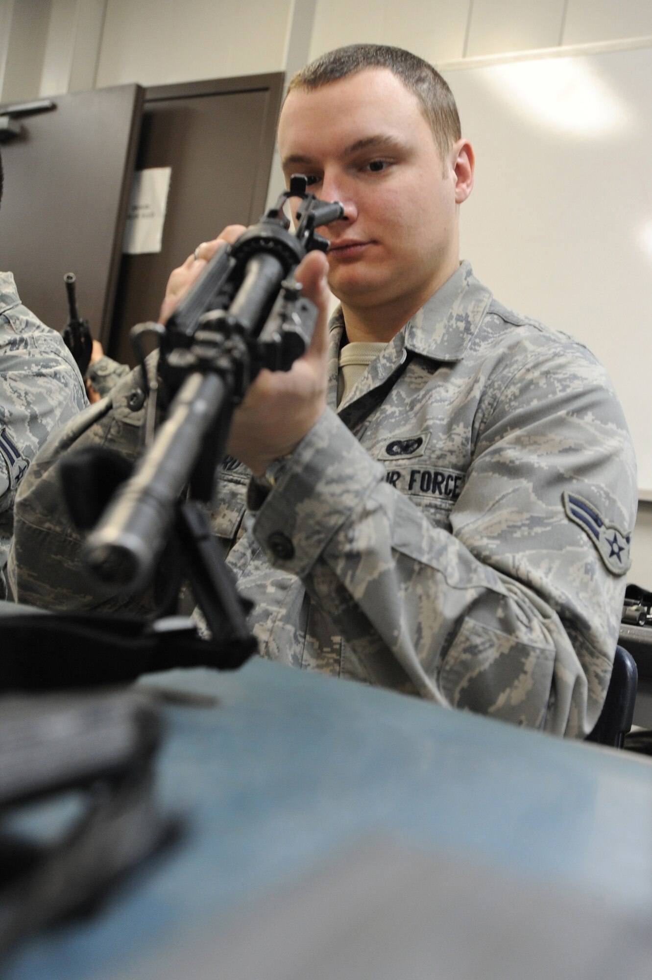 WHITEMAN AIR FORCE BASE, Mo. - Airman 1st Class Scott Maynard, 509th  Security Forces Squadron patrolman, inspects the barrel of his M-4 carbine to ensure no debris is stuck down inside during combat arms training here, March 16, 2010.(U.S. Air Force photo by Airman 1st Class Carlin Leslie )(Released)








