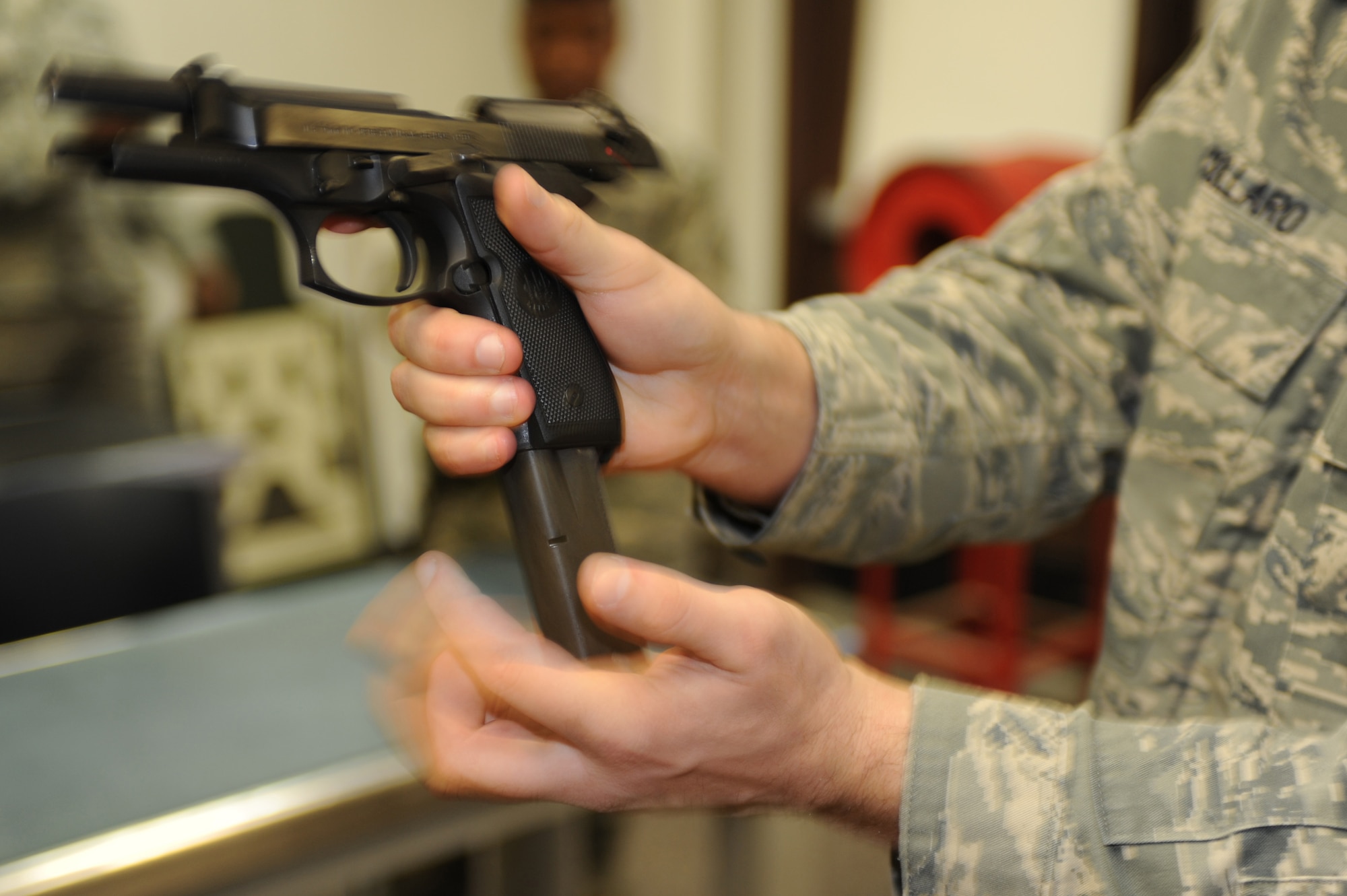 WHITEMAN AIR FORCE BASE, Mo. -  Senior Airman Robert Collaro, 509th Security Forces Squadron combat arms instructor, goes over the reload procedures for an M-9 at the Combat Arms Training and Maintenance facility here, March 16, 2010.(U.S. Air Force photo by Airman 1st Class Carlin Leslie )(Released)




