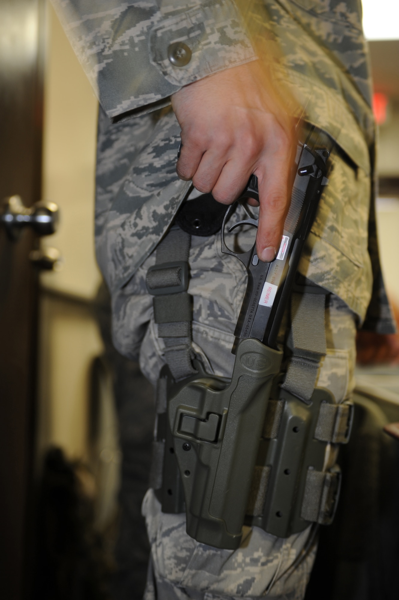 WHITEMAN AIR FORCE BASE, Mo. - An Airman draws his M-9 pistol, practicing unlocking the holster during combat arms training the Combat Arms Training and Maintenance facility here, March 16, 2010. (U.S. Air Force photo by Airman 1st Class Carlin Leslie)(Released)



