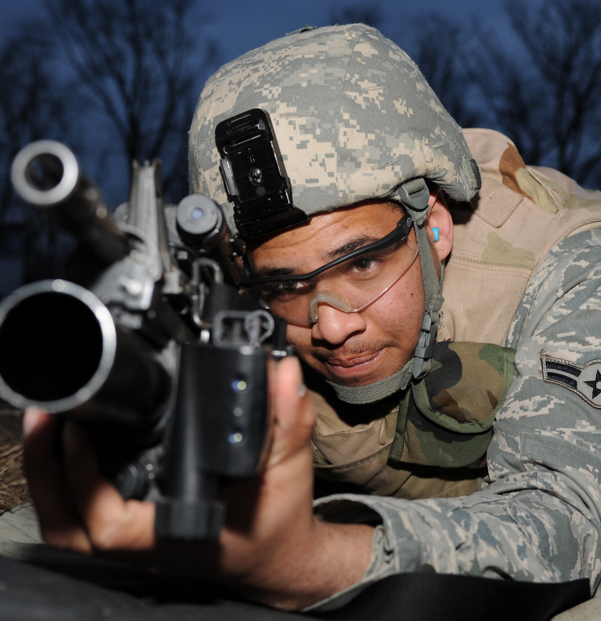 WHITEMAN AIR FORCE BASE, Mo. - Airman 1st Class Troy Young, 509th Security Forces Squadron, prepares to fire the M-203 grenade launcher attachment during training here March 8, 2010. (U.S. Air Force photo/Airman 1st Class Carlin Leslie) 

