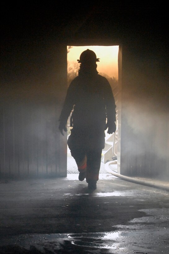 Joseph Thompson, 316th Civil Engineer Squadron fire protection assistant chief of operations, walks through the different layers of smoke in the live fire training building after live fire training March 5, 2010, at Joint Base Andrews Md. Live fire training is a necessary and indispensable tool for the 316th CES firefighters, which provides them with the ability to experience the heat and flames that can be found in a structure fire, but in a controlled environment. (U.S. Air Force photo by Airman 1st Class Perry Aston) (Released)
