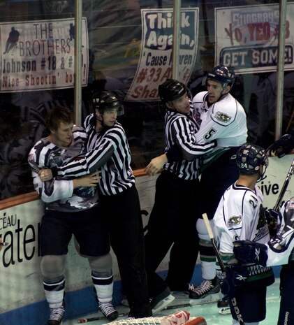 Members of the South Carolina Stingrays and Florida Everblades are pulled away from a fight in the third period during a hockey game March 12 at the North Charleston Coliseum. The Everblades trailed the Stingrays 0-3 in the  third period until a single goal prevented a shutout, ending the game in a 1-3 win for the Stingrays. (U.S. Air Force photo/Staff Sgt. Daniel Bowles)