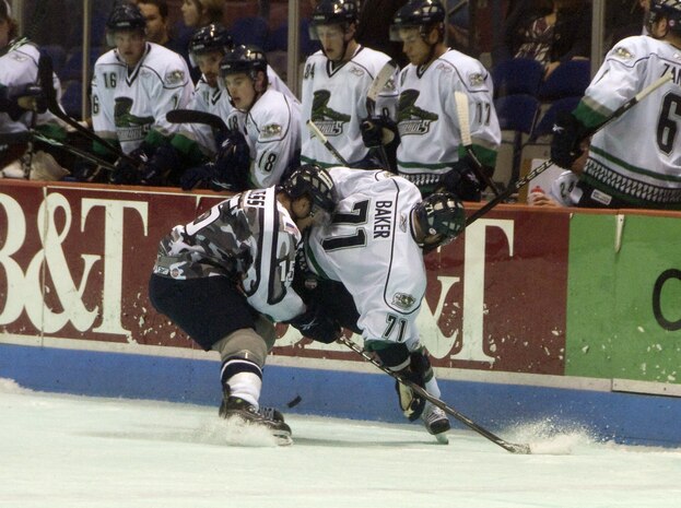 Right Wing Trevor Bruess battles for control of the puck with Right Wing Kevin Baker during the military appreciation night hosted at the North Charleston Coliseum March 12. The Stingrays defeated the Everblades 1-3, but were unable pull off another win in their rematch the following night. Bruess plays for the the South Carolina Stingrays and Baker plays for the Florida Everblades. (U.S. Air Force photo/Staff Sgt. Daniel Bowles)