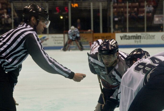 Forward Rob Ricci with the South Carolina Stingrays hockey team faces off against his Florida Everblades opponent, left wing Brandon Buck March 12 at the North Charleston Coliseum. The Stingrays captured a spot in the 2010 Kelly Cup Playoffs March 12 with their win against Florida. (U.S. Air Force photo/Staff Sgt. Daniel Bowles)