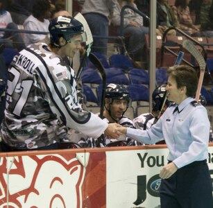 Col. Martha Meeker shakes hands with Defenseman Johann Kroll after the opening ceremony for the South Carolina Stingrays hockey team military appreciation night at the North Charleston Coliseum March 12. The event was held on a critical game for the team to enter the playoff season, with free tickets provided to military members serving at bases throughout South Carolina. Colonel Meeker is the 628th Air Base Wing commander. (U.S. Air Force photo/Staff Sgt. Daniel Bowles)