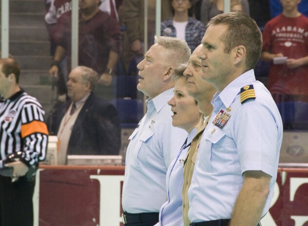 Col. Martha Meeker, center left, joins, from left, Col. William Stephens, Navy Cmdr. Gary Martin, and Coast Guard Capt. Michael McAllister at center ice for the singing of "God Bless America" at the start of the South Carolina Stingrays military appreciation night at the North Charleston Coliseum March 12. More than 5,000 fans attended the night's event with approximately 1,000 free tickets provided to military personnel. Colonel Meeker is the 628th Air Base Wing commander; Colonel Stephens is the 315th Mission Support Group commander; Commander Martin is the Naval Weapons Station Charleston commanding officer and Captain McAllister is the Coast Guard Sector Charleston commander. (U.S. Air Force photo/Staff Sgt. Daniel Bowles)