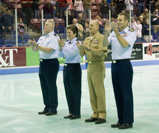 Col. Martha Meeker, center left, joins, from left, Col. William Stephens, Navy Cmdr. Gary Martin, and Coast Guard Capt. Michael McAllister at center ice at the start of the South Carolina Stingrays military appreciation night at the North Charleston Coliseum March 12. The Stingrays donated approximately 1,000 tickets for the game to military members in and around Charleston, Beaufort and Columbia. Colonel Meeker is the 628th Air Base Wing commander; Colonel Stephens is the 315th Mission Support Group commander; Commander Martin is the Naval Weapons Station Charleston commanding officer and Captain McAllister is the Coast Guard Sector Charleston commander. (U.S. Air Force photo/Staff Sgt. Daniel Bowles)