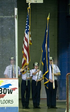 Students with R.B. Stall High School's Air Force Junior Reserve Officers' Training Corps unit present the colors during the national anthem at the South Carolina Stingrays military appreciation night at the North Charleston Coliseum. The intent and motto of the JROTC unit is to build better citizens for America. The JROTC's unit is Squadron SC-031. (U.S. Air Force photo/Staff Sgt. Daniel Bowles)