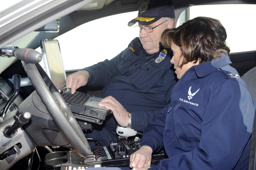 Maj. John Dove, Department of the Air Force civilian police officer, shows Col. Gina Grosso, Joint Base McGuire-Dix-Lakehurst commander, how  JB MDL security forces use the mobile data terminal inside the new police vehicles to run names and liscence plates to check warrants during traffic stops. The new vehicles also feature front and rear mounted speed radar and cameras that record all traffics stops.
(U.S. Air Force photo/Carlos Cintron)
