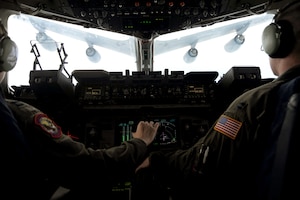 Capt. Kevin Shaffer and Capt. Kristen Franke carefully maneuver their Charleston C-17 Globemaster III beneath a KC-135 Stratotanker from the 927th Air Refueling Wing, MacDill AFB, Fla., during a local training mission on March 9 for refueling. The refuel was part of a routine training mission geared toward honing airlift capabilities for expanding global reach. Captains Shaffer and Franke are pilots with the 15th Airlift Squadron. (U.S. Air Force photo/Tech. Sgt. Dennis Henry)