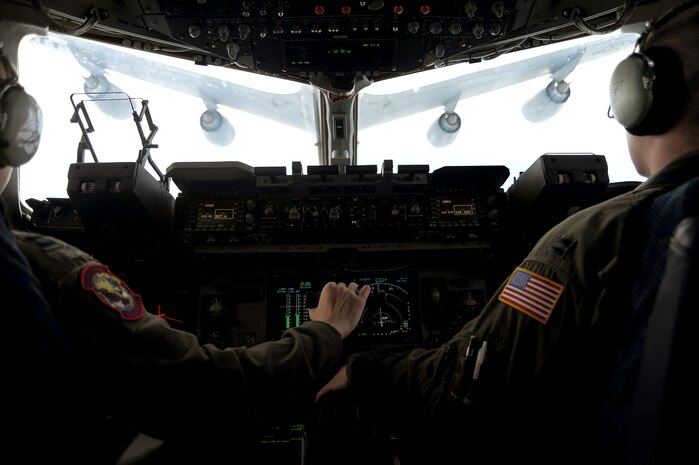 Capt. Kevin Shaffer and Capt. Kristen Franke carefully maneuver their Charleston C-17 Globemaster III beneath a KC-135 Stratotanker from the 927th Air Refueling Wing, MacDill AFB, Fla., during a local training mission on March 9 for refueling. The refuel was part of a routine training mission geared toward honing airlift capabilities for expanding global reach. Captains Shaffer and Franke are pilots with the 15th Airlift Squadron. (U.S. Air Force photo/Tech. Sgt. Dennis Henry)