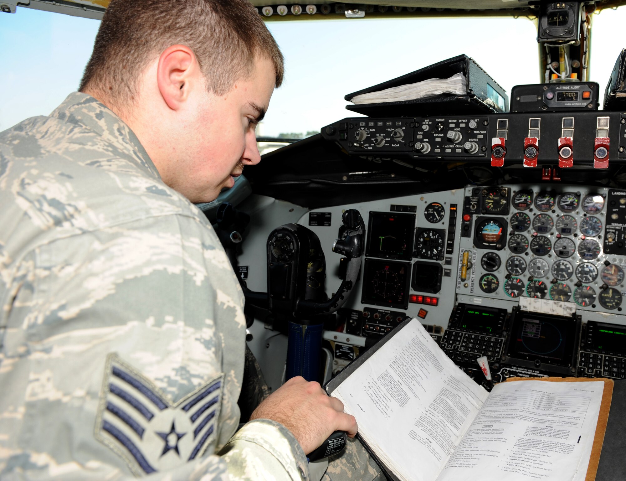 Staff Sgt. Dwayne Elders, 911th Air Refueling Squadron avionics craftsman, reads a technical order for initiating a KC-135R Stratotanker inertial navigation system before performing a flight control systems test on Seymour Johnson Air Force Base, N.C., March 15, 2010. Elders performs flight control systems tests to ensure the autopilot is running properly. Elder hails from Dearborn, Mich. (U.S. Air Force photo/Airman 1st Class Gino Reyes)