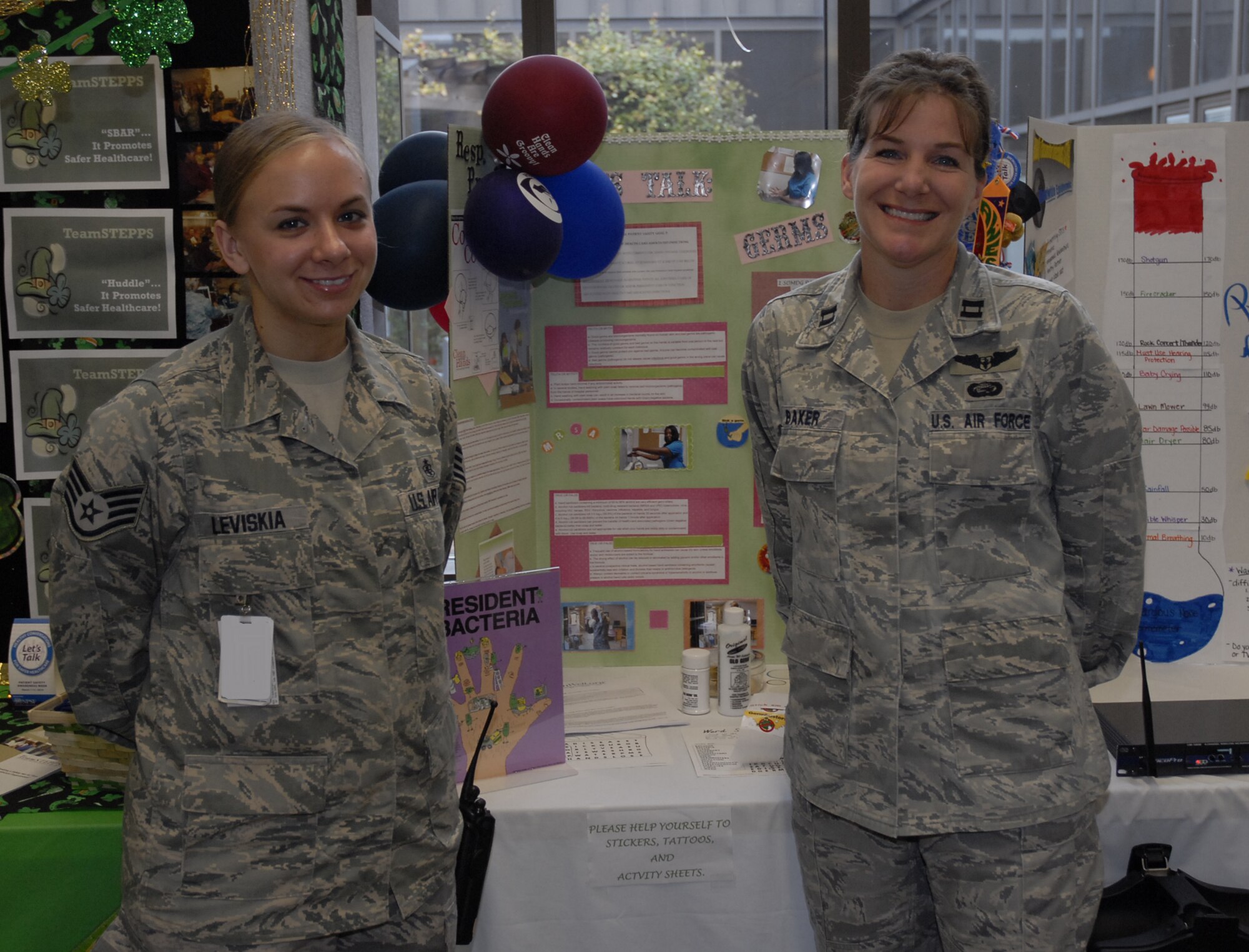 Capt. Dana Baker, 1st Special Operations Aerospace Medicine Squadron, and Staff Sgt. Alissa Leviskia, 1st Special Operations Medical Operations Squadron, pose in front of their top-winning poster “Let’s Talk Germs” at the 1st Special Operations Medical Group clinic at Hurlburt Field March 12. The 1st SOMDG marked its second annual National Patient Safety Awareness Week, a national education and awareness-building campaign for improving patient safety at the local level. (U.S. Air Force photo by Airman 1st Class Joe McFadden)