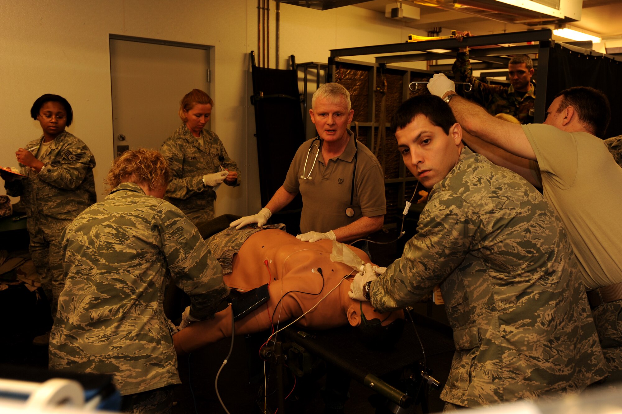 Dr. Thomas McKnight, center, and 1st Lt. Lance Camacho, right, of the 1st Special Operations Medical Operations Squadron check the computer readings of a training mannequin during an exercise at the 1st Special Operations Medical Group laboratory at Hurlburt Field March 11. The 1st SOMDG marked its second annual National Patient Safety Awareness Week, a national education and awareness-building campaign for improving patient safety at the local level. (U.S. Air Force photo by Senior Airman Matthew Loken)