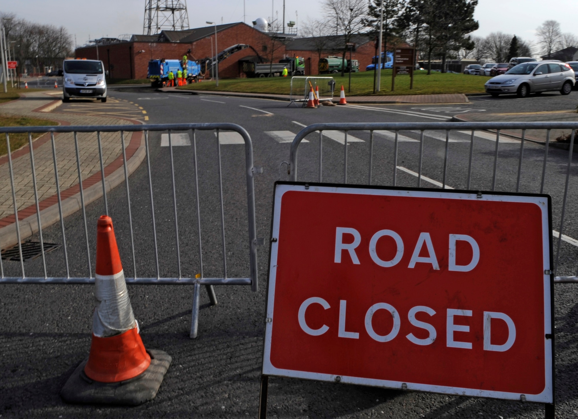 RAF MILDENHALL, England – Local contractors block off the road near building 591 March 17.  The road, which is typically used for traveling to the north side of base, will be reopen after it is resurfaced.  (U.S. Air Force photo/Staff Sgt. Christopher L. Ingersoll)