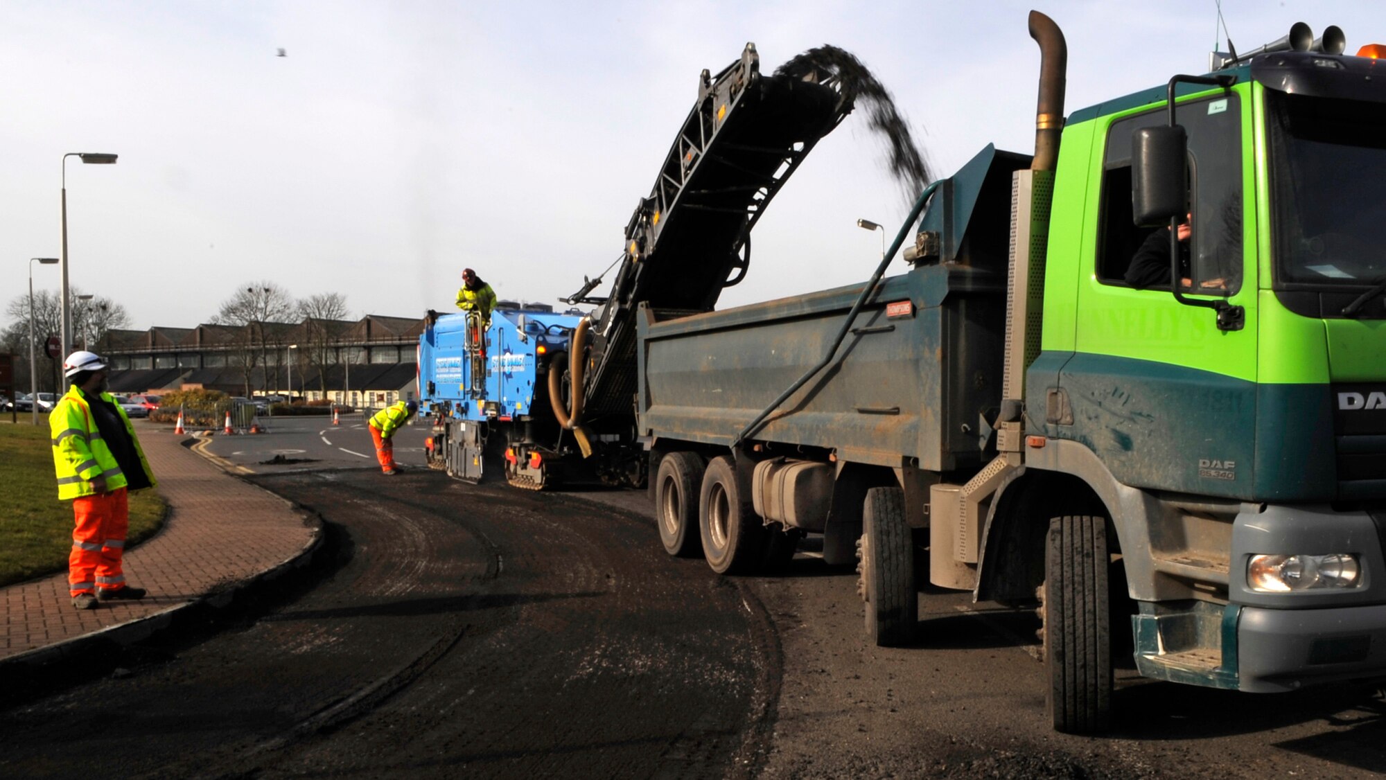 RAF MILDENHALL, England – Local contractors drive a planer to prepare the road for resurfacing near Building 591 March 17.  The repair is scheduled to be followed by another near Building 425.  (U.S. Air Force photo/Staff Sgt. Christopher L. Ingersoll)
