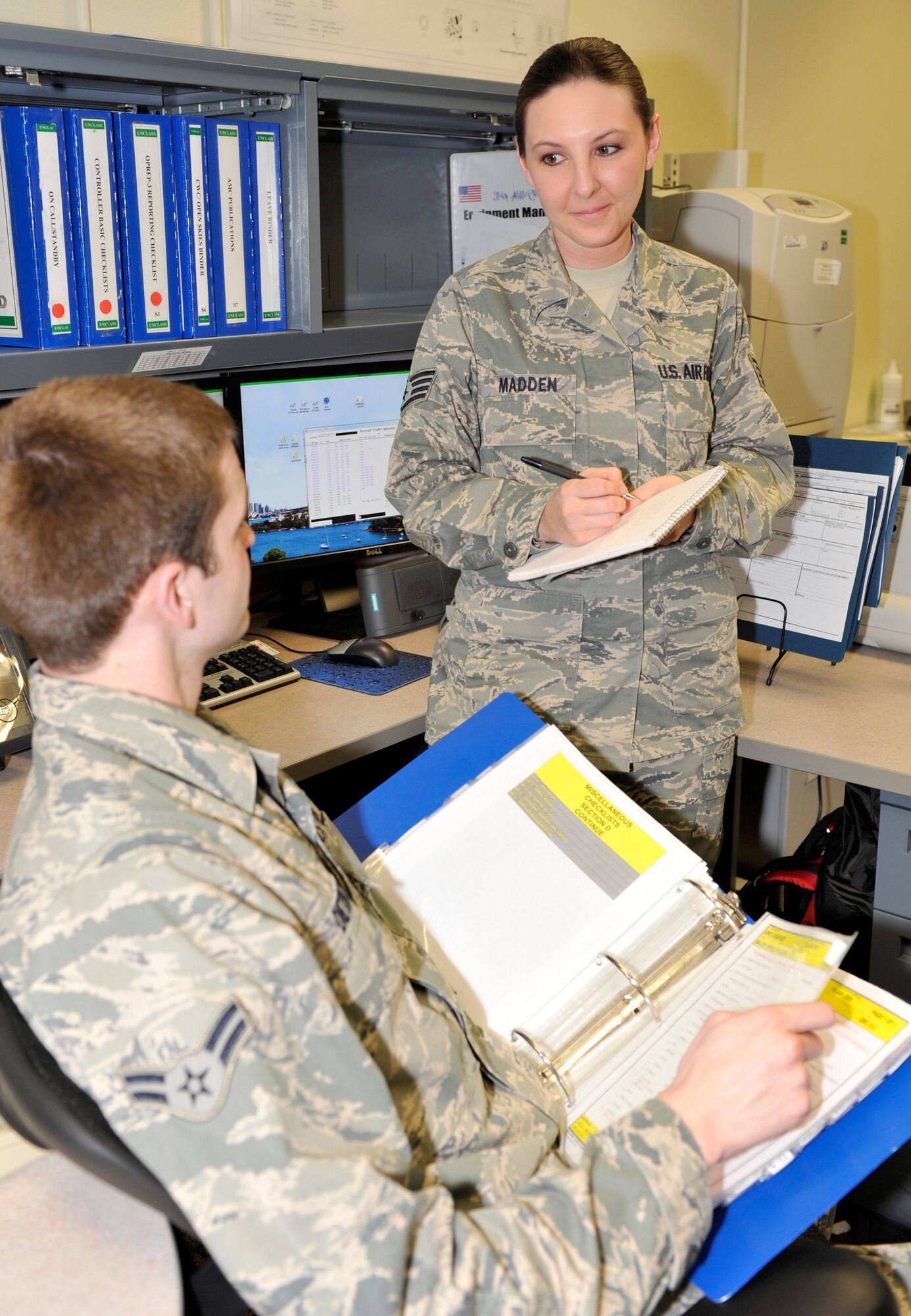Staff Sgt. Karlie Madden, 19th Airlift Wing Command Post NCO-in-charge of training, conducts scenario training with an Airman March 16. Sergeant Madden was selected as the Combat Airlifter of the Week for her involvement in conducting emergency action scenario training for 17 controllers, with a 97 percent monthly test score average. (U.S. Air Force photo by Senior Airman Christine Clark)