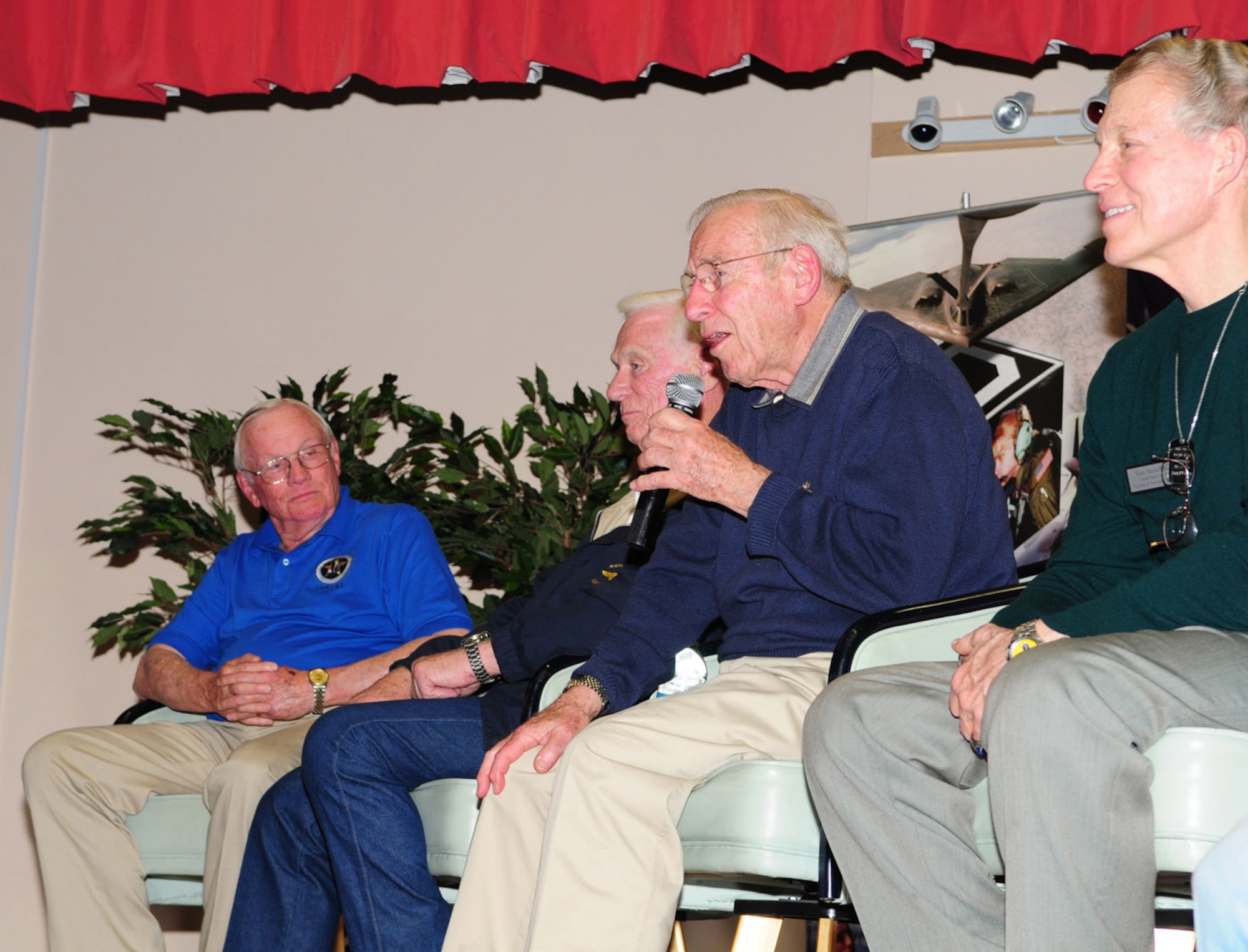 RAF MILDENHALL, England -- Jim Lovell, Apollo 13 commander, shares his stories and experiences with an audience March 11 at the Galaxy Club here during the “Legends of Aerospace: The Impossible is Possible” tour. Neil Armstrong, the first man on the moon (left), Gene Cernan, the last man on the moon, and Steve Ritchie, the last Air Force pilot ace (right), were also part of the tour. (U.S. Air Force photo/Karen Abeyasekere)