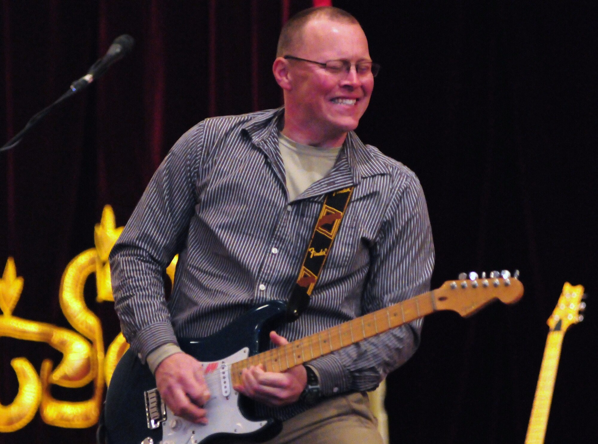 Senior Airman Josh Byrd, guitarist for the U.S. Air Forces Central Public Affairs band “Reserve Generation,” entertains the audience at the House of Culture, Tokmok, Kyrgyzstan, March 12, 2010. The band visited the Transit Center at Manas during their two-month tour throughout the area of responsibility, where they performed five concerts in the local community and twice on the installation. (U.S. Air Force photo/Senior Master Sgt. Mike Litsey/Released)