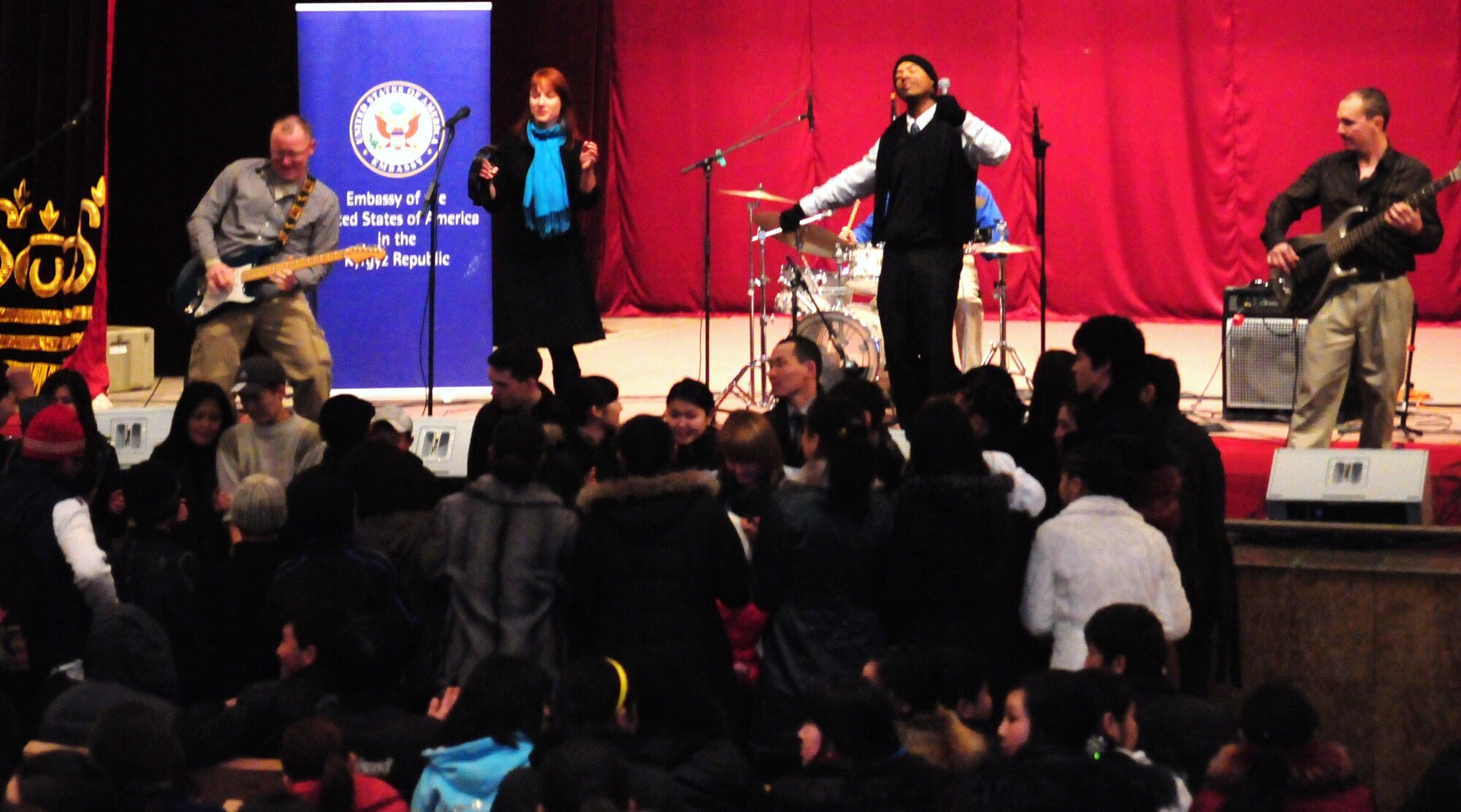 The U.S. Air Forces Central Public Affairs band “Reserve Generation,” entertains the audience at the House of Culture, Tokmok, Kyrgyzstan, March 12, 2010. The band visited the Transit Center at Manas during their two-month tour throughout the area of responsibility, where they performed five concerts in the local community and twice on the installation. (U.S. Air Force photo/Senior Master Sgt. Mike Litsey/Released)