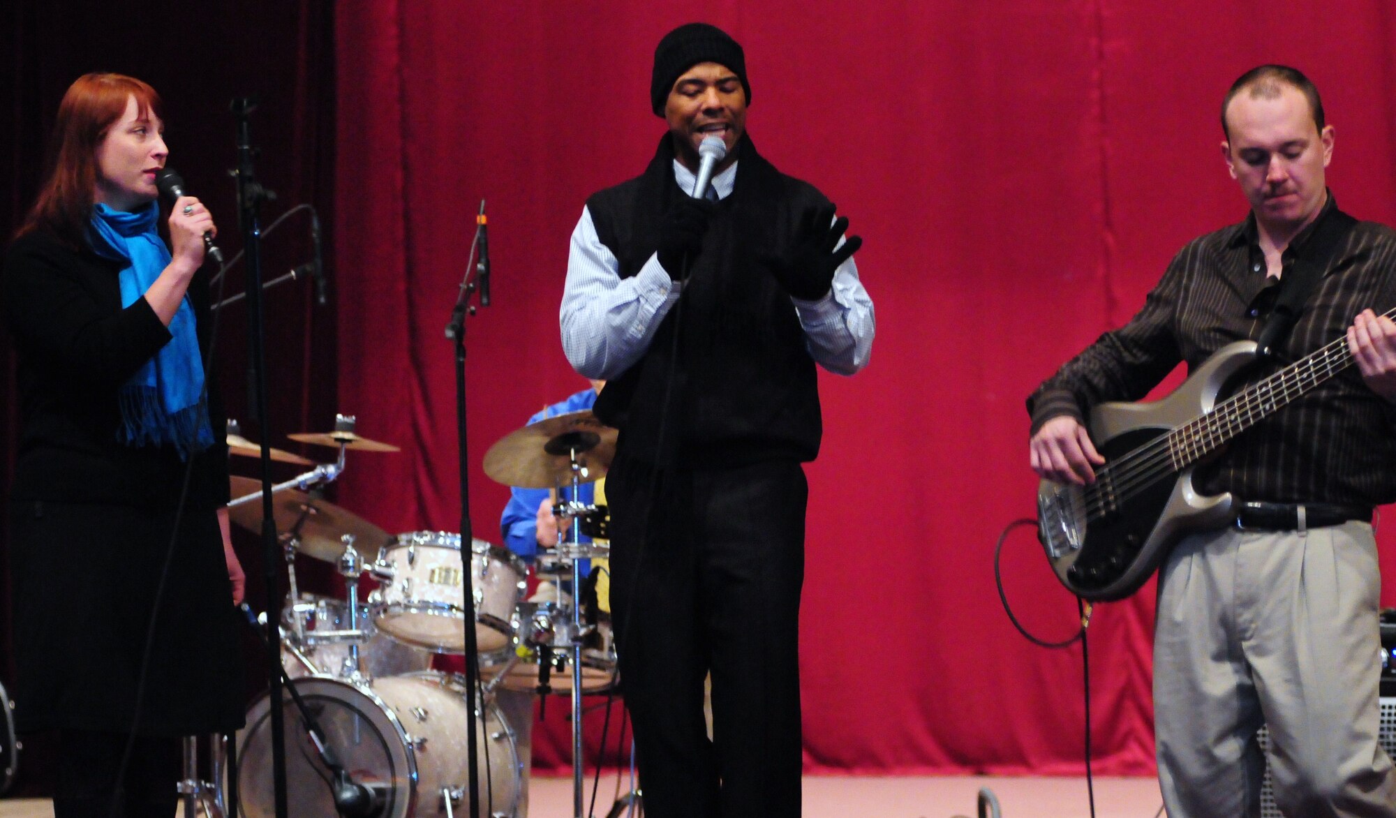 Airman 1st Class Jill Marie Diem, Master Sgt. Aaron Miles, and Airman 1st Class Darren King, members of the U.S. Air Forces Central Public Affairs band “Reserve Generation,” entertain the audience during a concert at the House of Culture, Tokmok, Kyrgyzstan, March 12, 2010. (U.S. Air Force photo/Senior Master Sgt. Mike Litsey/Released)