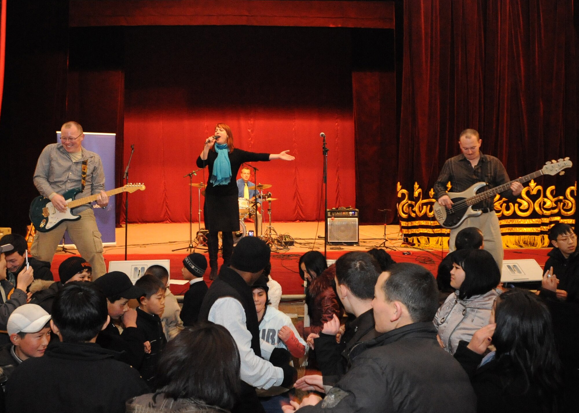 U.S. Air Forces Central Public Affairs band ?Reserve Generation? draws audience members out of their seat and onto the dance floor during their performance at the House of Culture in Tokmok, Kyrgyzstan, March 12, 2010. The band played and sang at five local venues and twice at the Transit Center at Manas during their tour through Kyrgyzstan March 5 to 14, 2010. (U.S. Air Force photo/Senior Airman Nichelle Anderson/released)