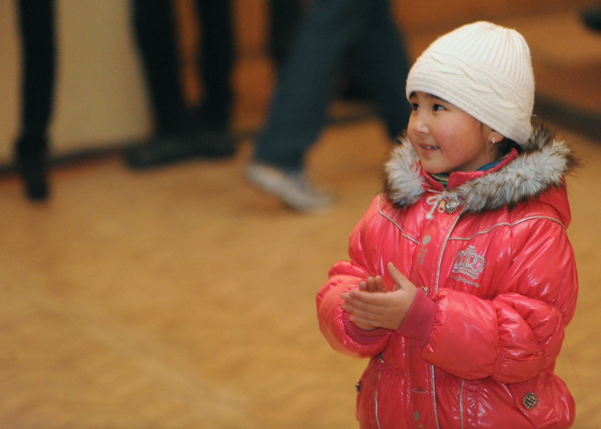 A young child stands near the edge of the stage and claps after a set by U.S. Air Forces Central Public Affairs band ?Reserve Generation? at the House of Culture in Tokmok, Kyrgyzstan, March 12, 2010. (U.S. Air Force photo/Senior Airman Nichelle Anderson/released)