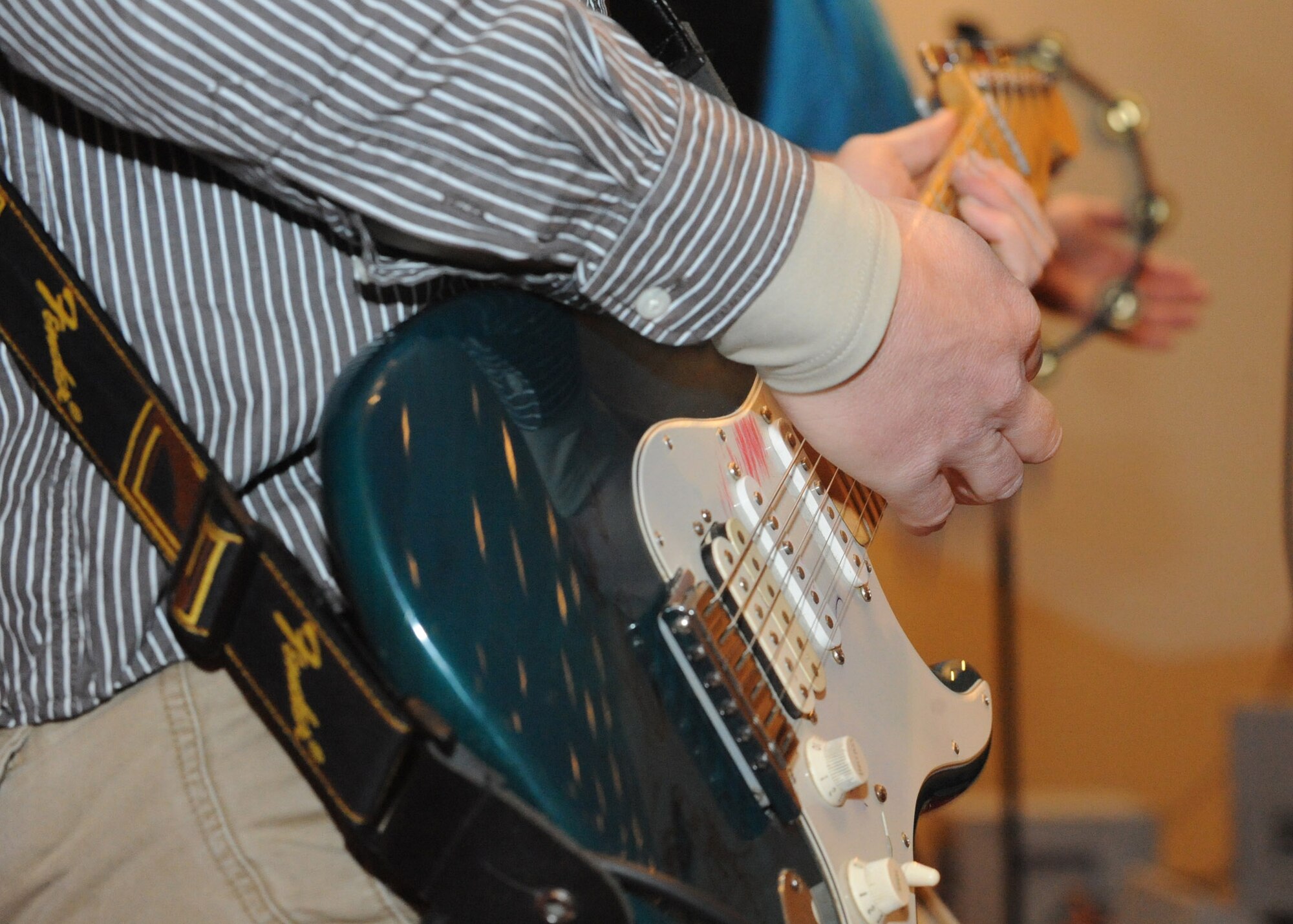 Senior Airman Josh Byrd, guitarist for the U.S. Air Forces Central Public Affairs band ?Reserve Generation,? performs for hundreds of men and women of all ages at the House of Culture in Tokmok, Kyrgyzstan, March 12, 2010. (U.S. Air Force photo/Senior Airman Nichelle Anderson/released)