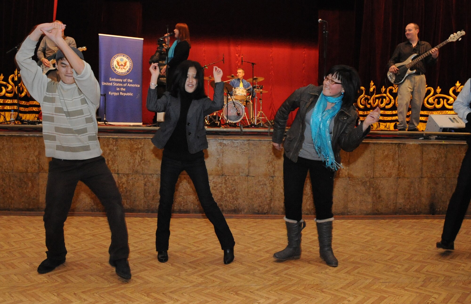 U.S. Air Forces Central Public Affairs band ?Reserve Generation? draws audience members out of their seat and onto the dance floor during their performance at the House of Culture in Tokmok, Kyrgyzstan, March 12, 2010. The band played and sang at five local venues and twice at the Transit Center at Manas during their tour through Kyrgyzstan March 5 to 14, 2010. (U.S. Air Force photo/Senior Airman Nichelle Anderson/released)