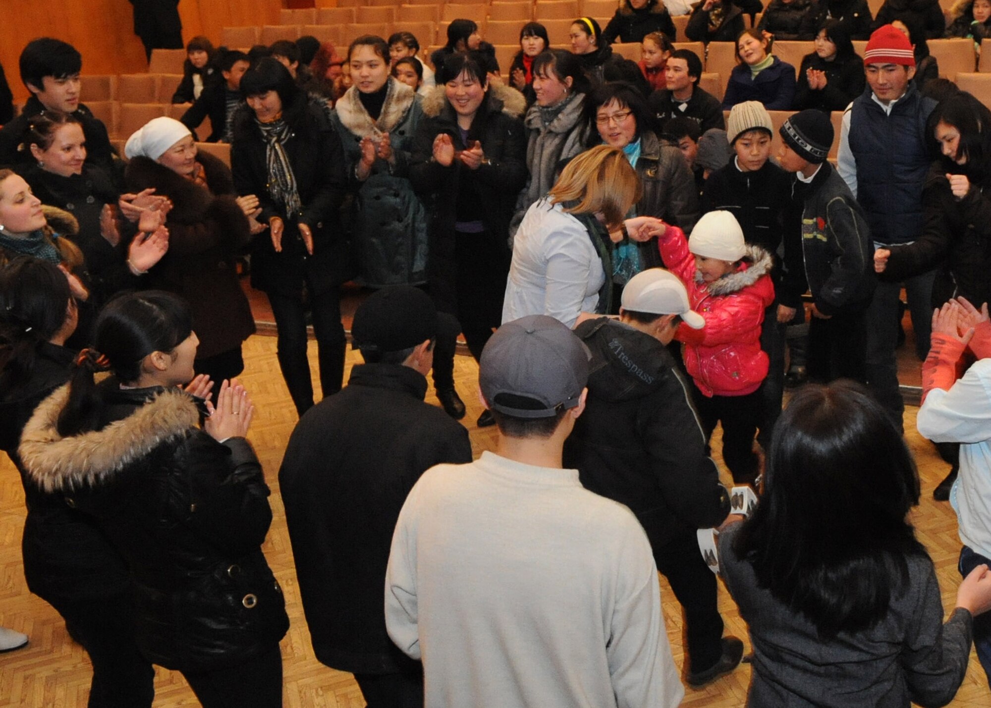 U.S. Air Forces Central Public Affairs band ?Reserve Generation? draws audience members out of their seat and onto the dance floor during their performance at the House of Culture in Tokmok, Kyrgyzstan, March 12, 2010. The band played and sang at five local venues and twice at the Transit Center at Manas during their tour through Kyrgyzstan March 5 to 14, 2010. (U.S. Air Force photo/Senior Airman Nichelle Anderson/released)