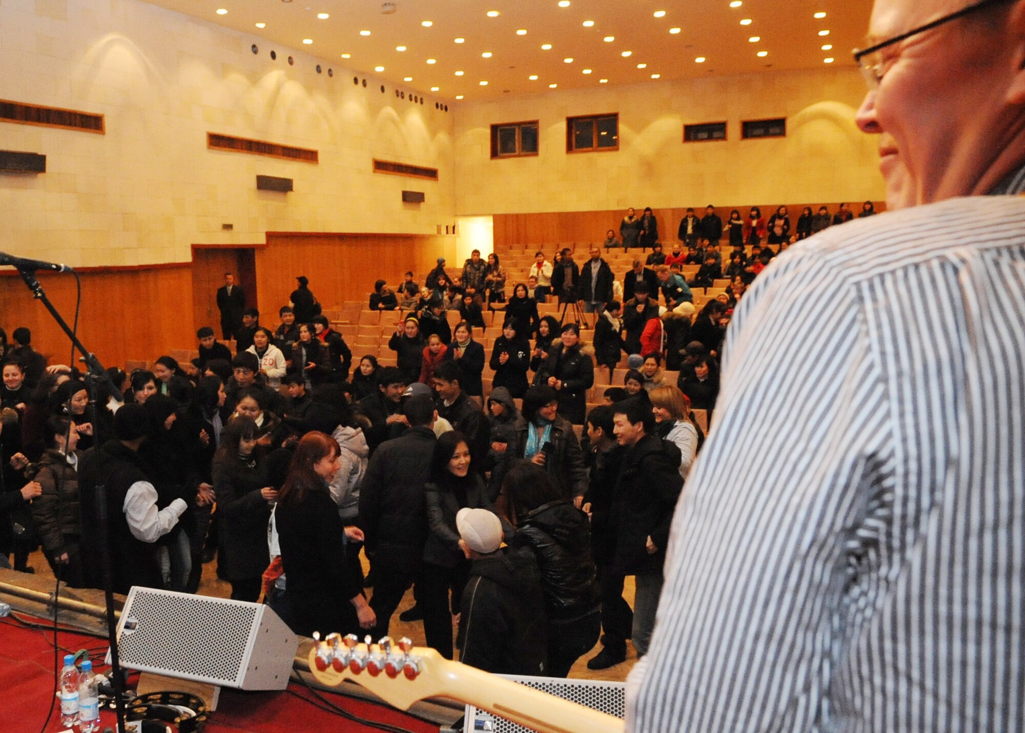 Senior Airman Josh Byrd, guitarist for the U.S. Air Forces Central Public Affairs band ?Reserve Generation,? performs for hundreds of men and women of all ages at the House of Culture in Tokmok, Kyrgyzstan, March 12, 2010. (U.S. Air Force photo/Senior Airman Nichelle Anderson/released)