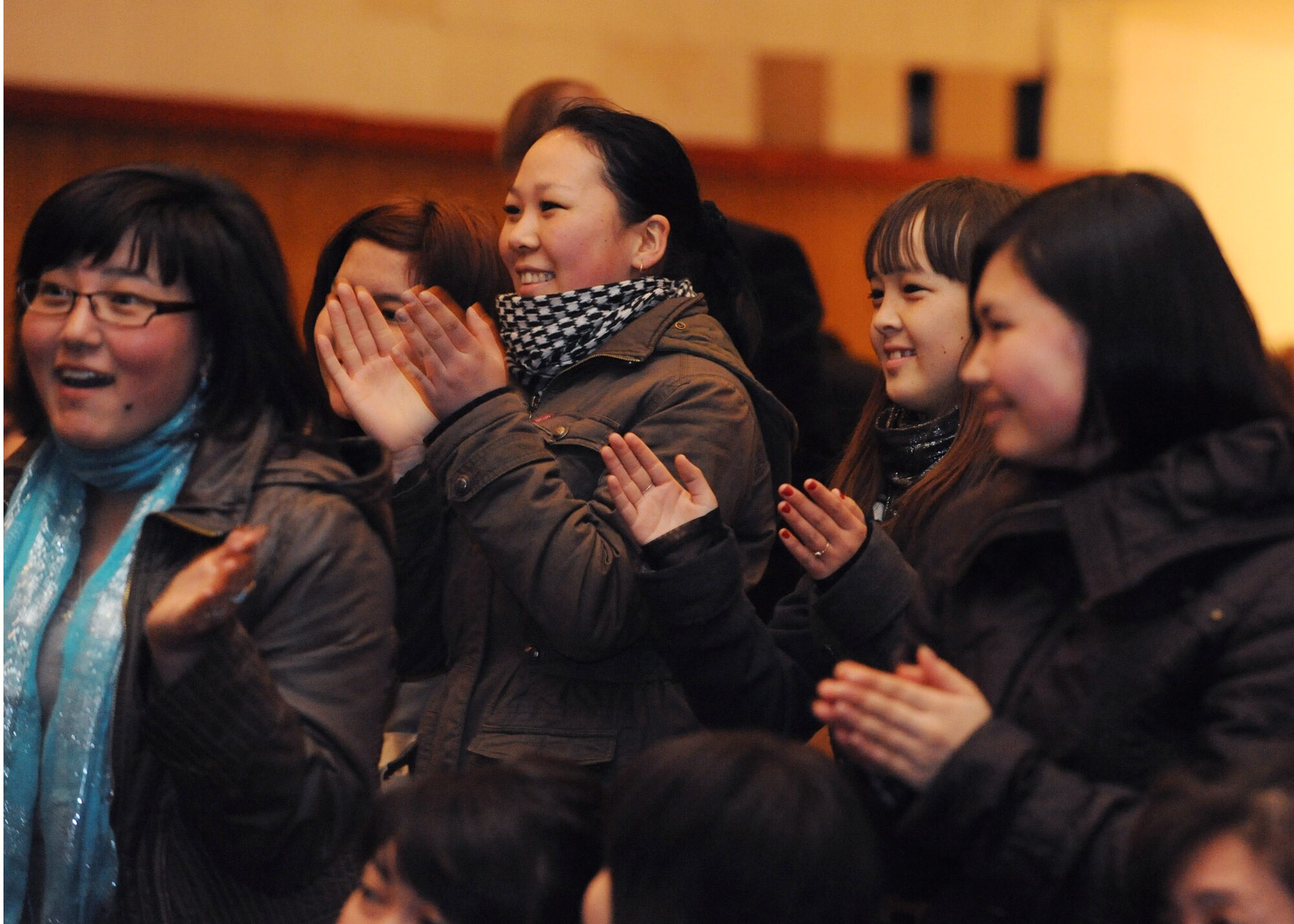 Audience members cheer during a performance by the U.S. Air Forces Central Public Affairs band ?Reserve Generation? at the House of Culture in Tokmok, Kyrgyzstan, March 12, 2010. Reserve Generation had the unique opportunity to play for the local community during their 60-day tour through Southwest Asia. (U.S. Air Force photo/Senior Airman Nichelle Anderson/released)
