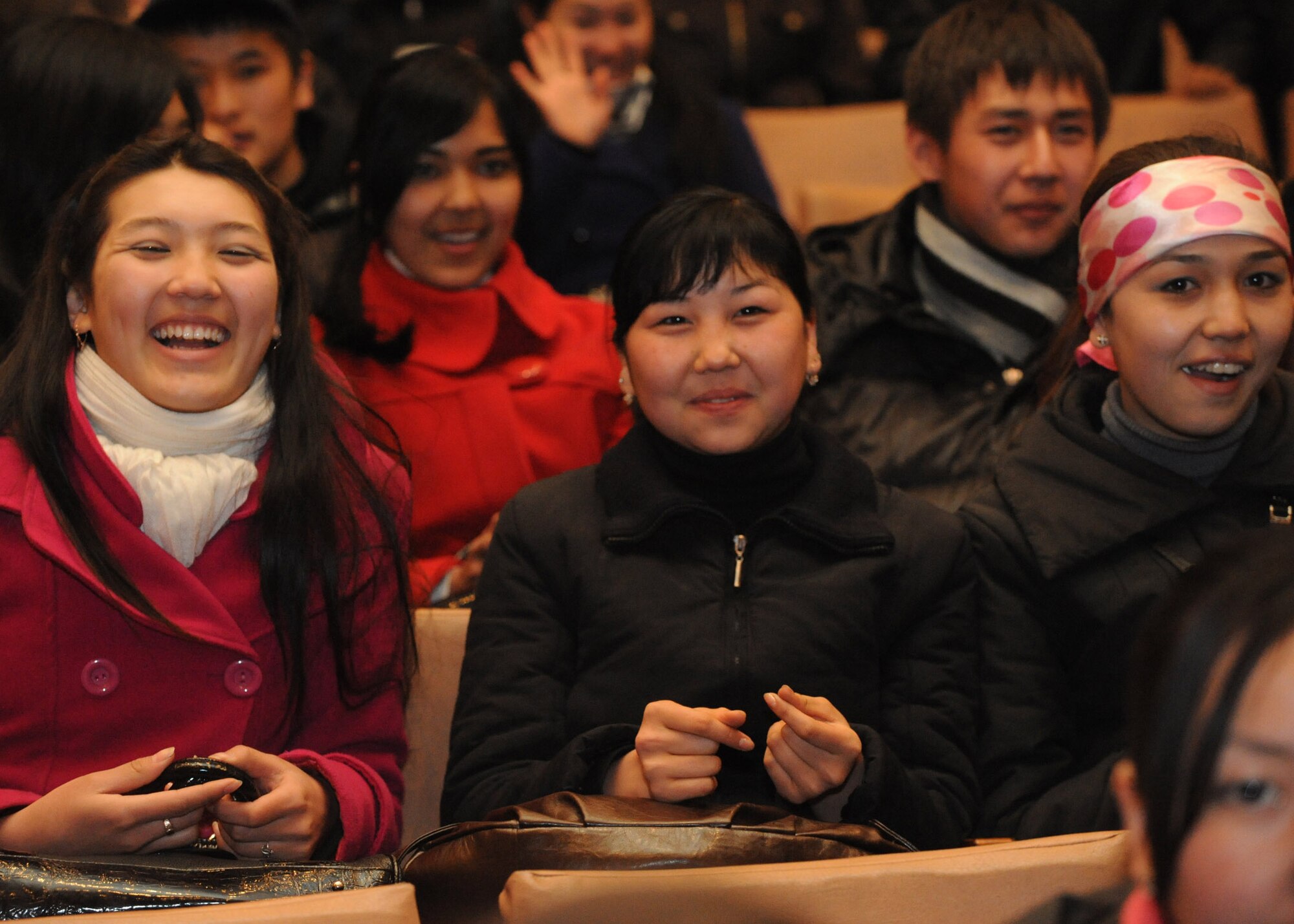 Audience members cheer during a performance by the U.S. Air Forces Central Public Affairs band ?Reserve Generation? at the House of Culture in Tokmok, Kyrgyzstan, March 12, 2010. Reserve Generation had the unique opportunity to play for the local community during their 60-day tour through Southwest Asia. (U.S. Air Force photo/Senior Airman Nichelle Anderson/released)