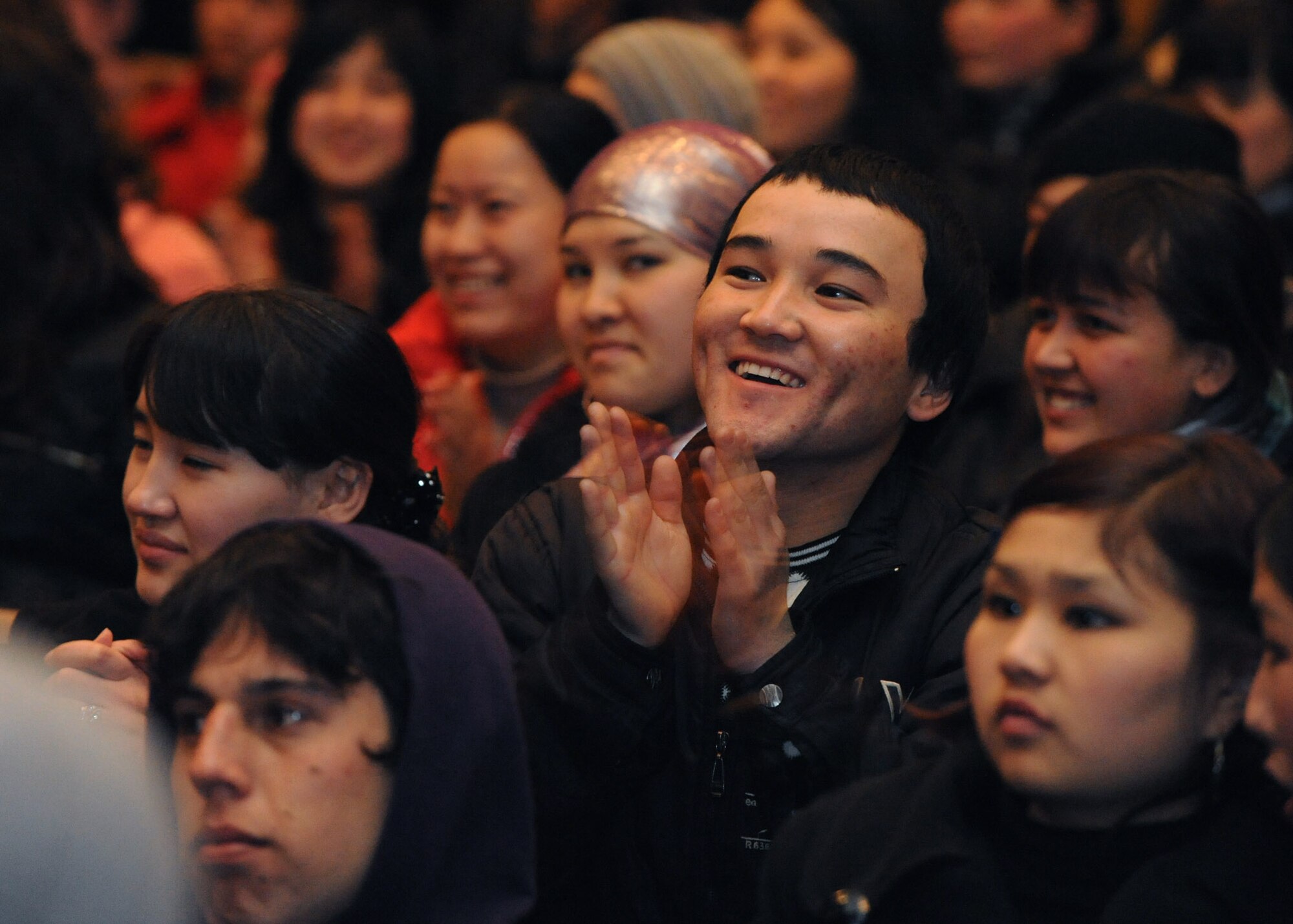 Audience members cheer during a performance by the U.S. Air Forces Central Public Affairs band ?Reserve Generation? at the House of Culture in Tokmok, Kyrgyzstan, March 12, 2010. Reserve Generation had the unique opportunity to play for the local community during their 60-day tour through Southwest Asia. (U.S. Air Force photo/Senior Airman Nichelle Anderson/released)