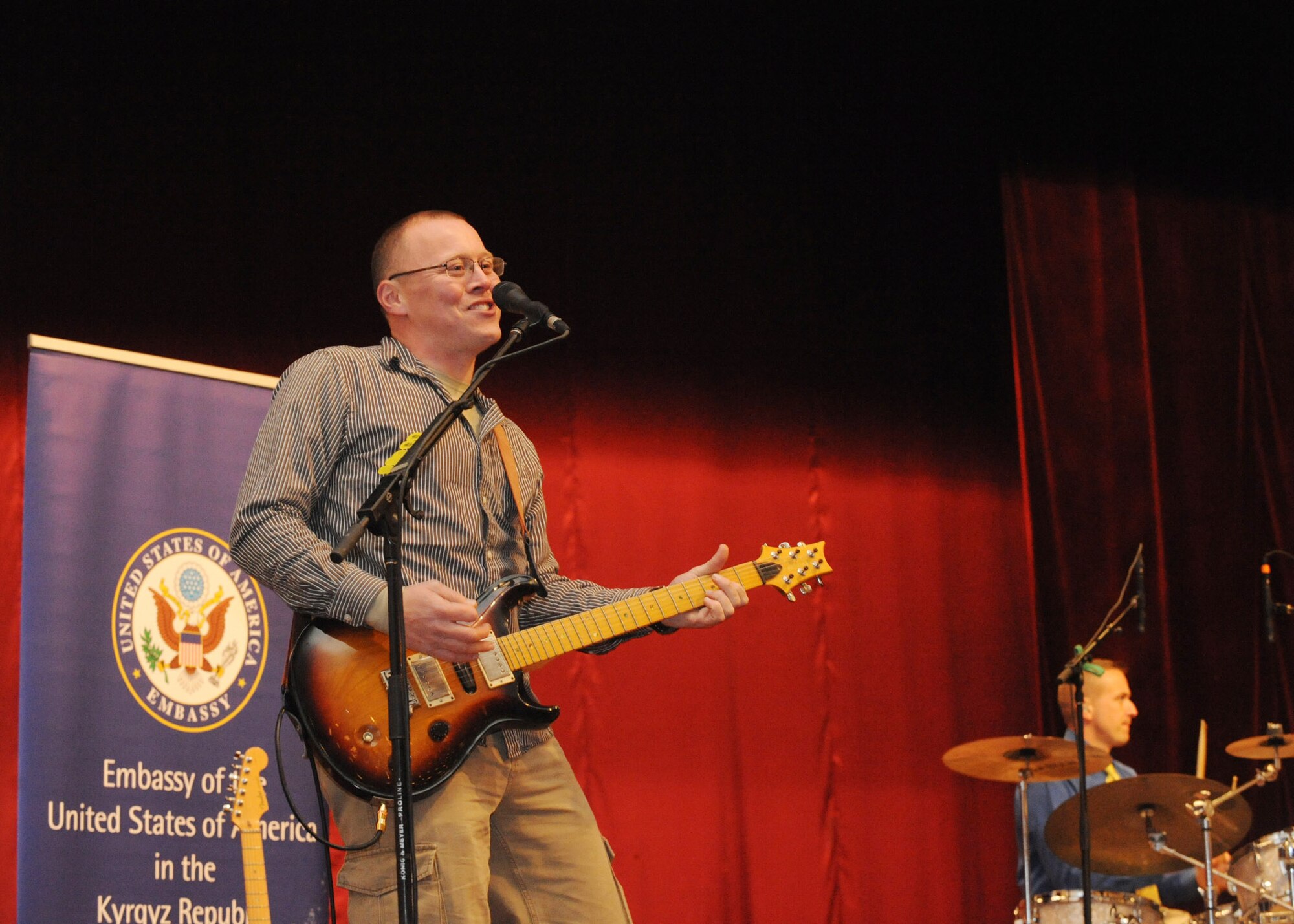Senior Airman Josh Byrd, guitarist for the U.S. Air Forces Central Public Affairs band ?Reserve Generation,? performs for hundreds of men and women of all ages at the House of Culture in Tokmok, Kyrgyzstan, March 12, 2010. (U.S. Air Force photo/Senior Airman Nichelle Anderson/released)