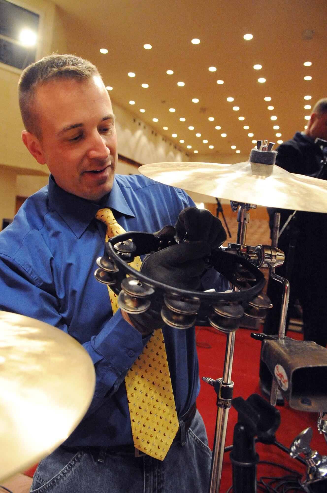 Tech. Sgt. David Vittetoe, drummer for the U.S. Air Forces Central Public Affairs band ?Reserve Generation,? sets up prior to performing for local citizens at the House of Culture in Tokmok, Kyrgyzstan, March 12, 2010.